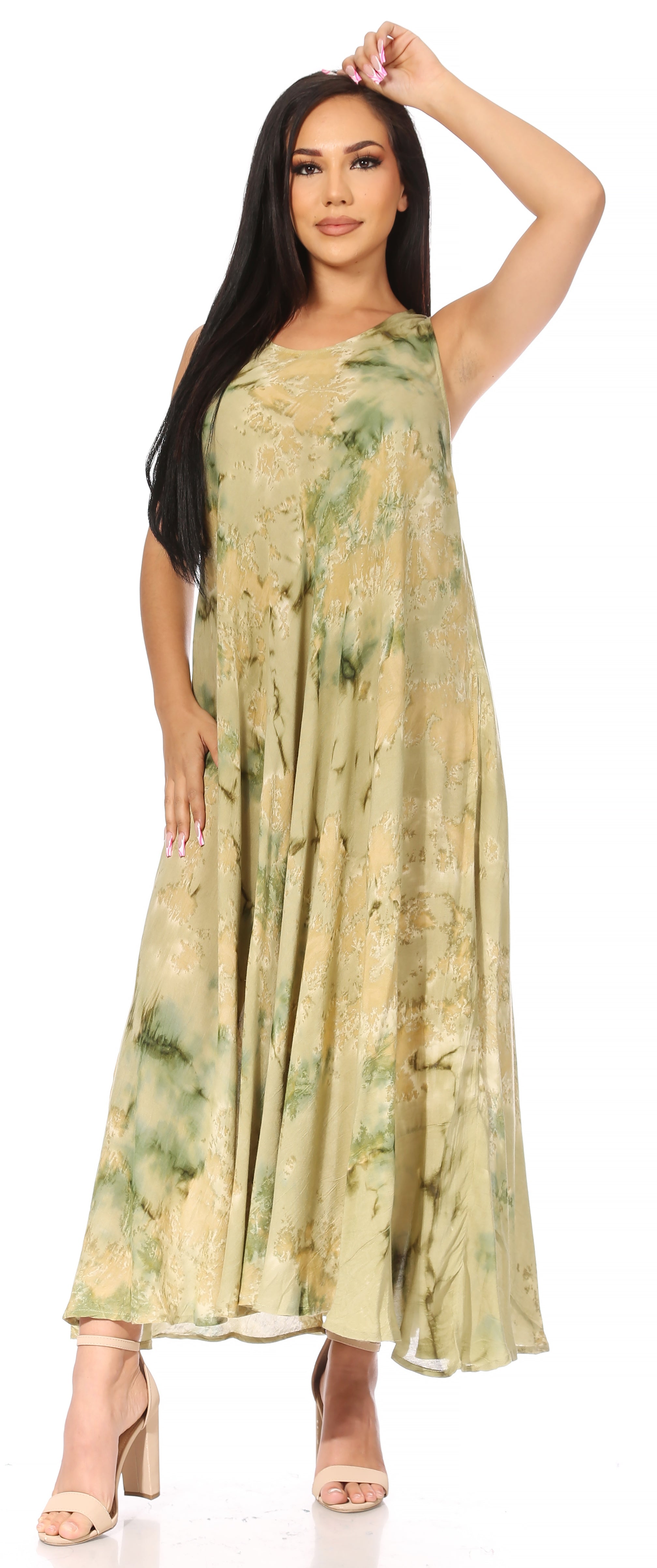 Woman wearing a long, light-colored dress with floral patterns on a white background