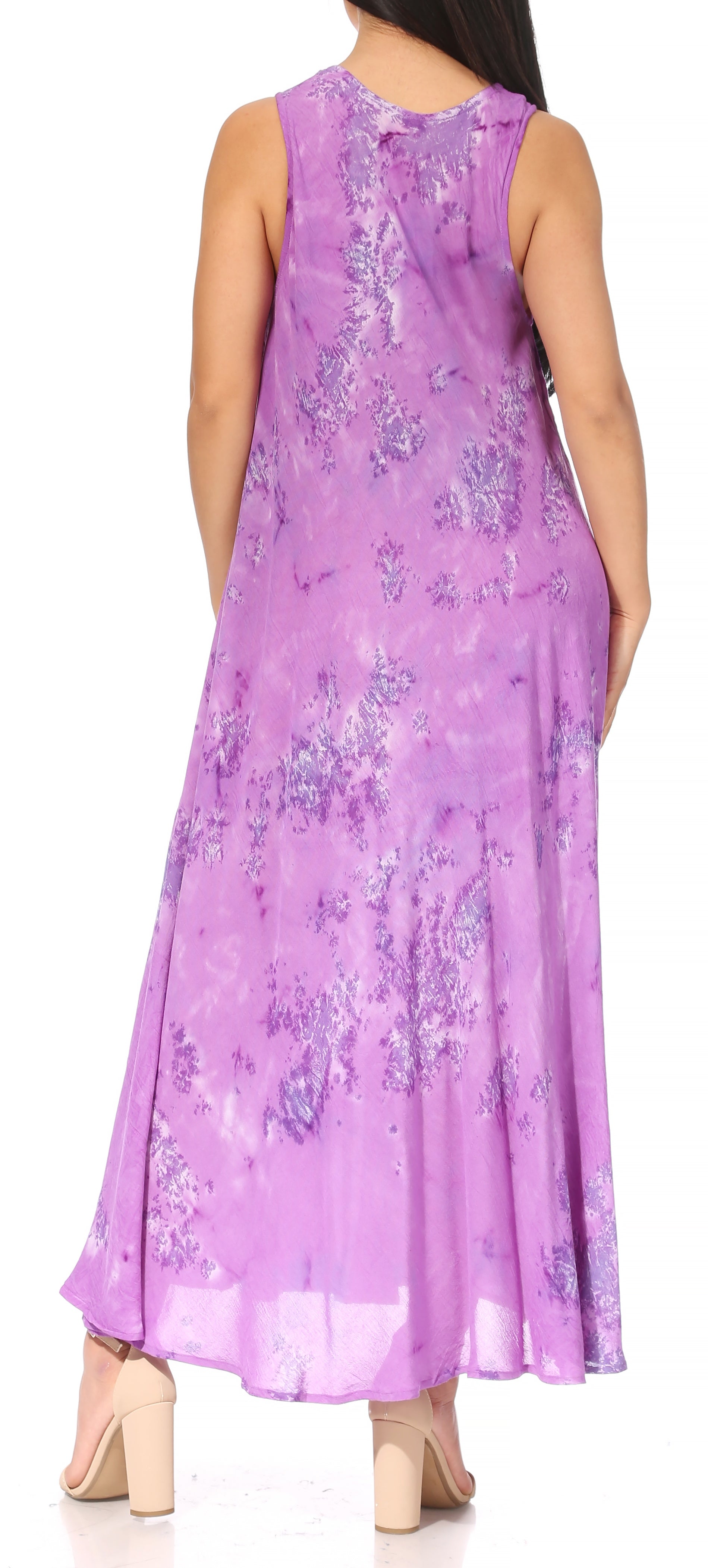 Woman wearing a purple floral dress against a neutral background