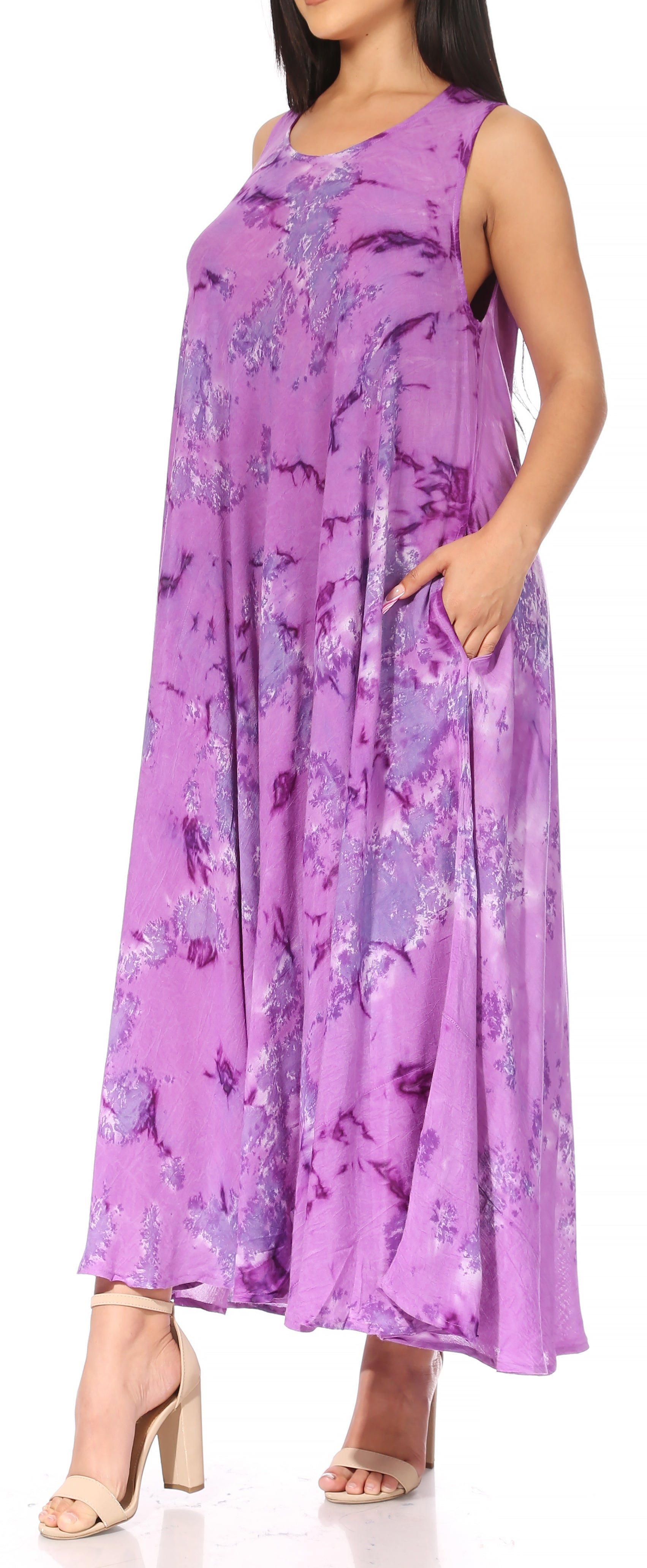 Woman wearing a sleeveless purple floral dress on a white background