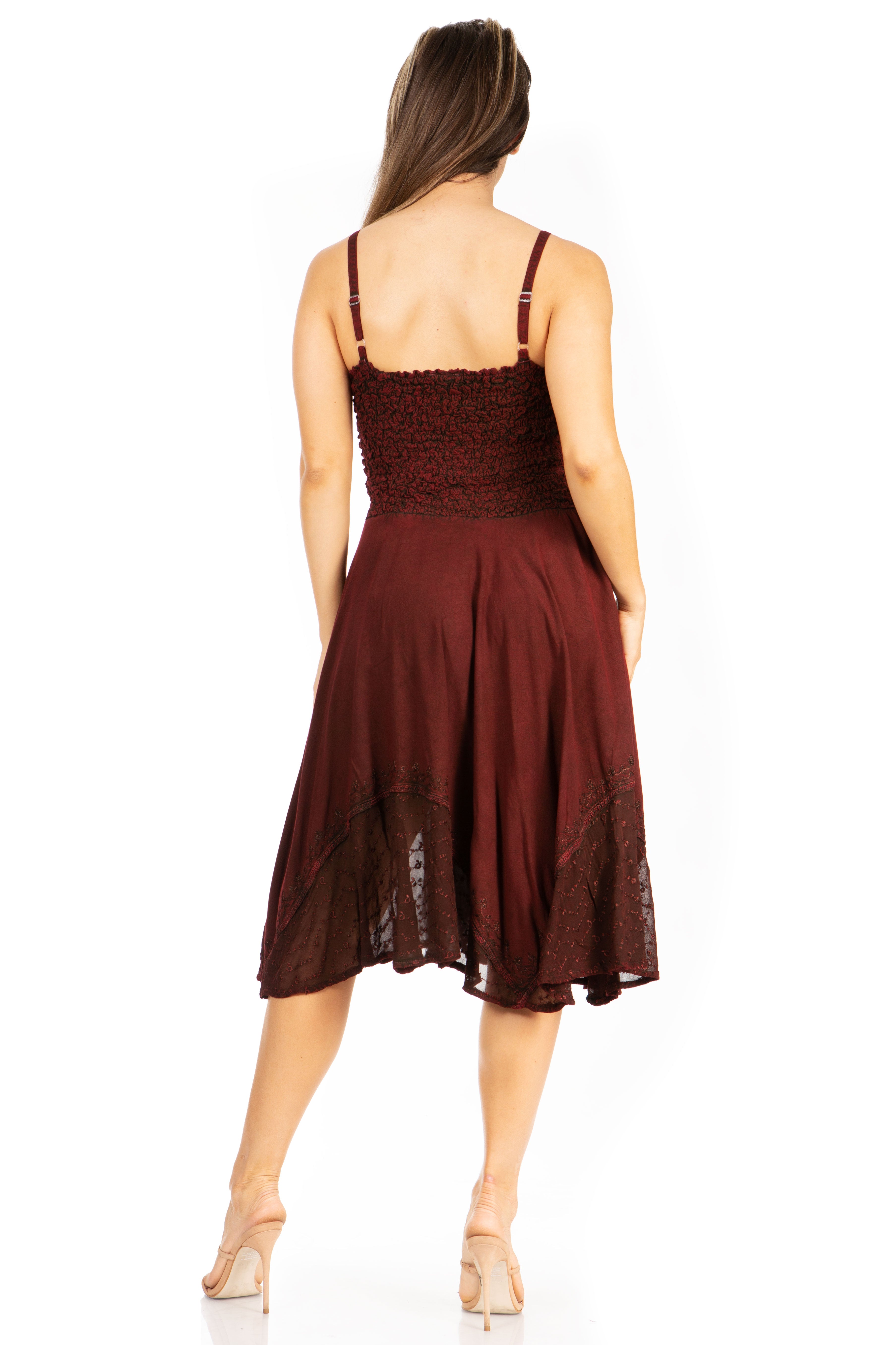 Woman wearing a burgundy dress with lace details on a white background