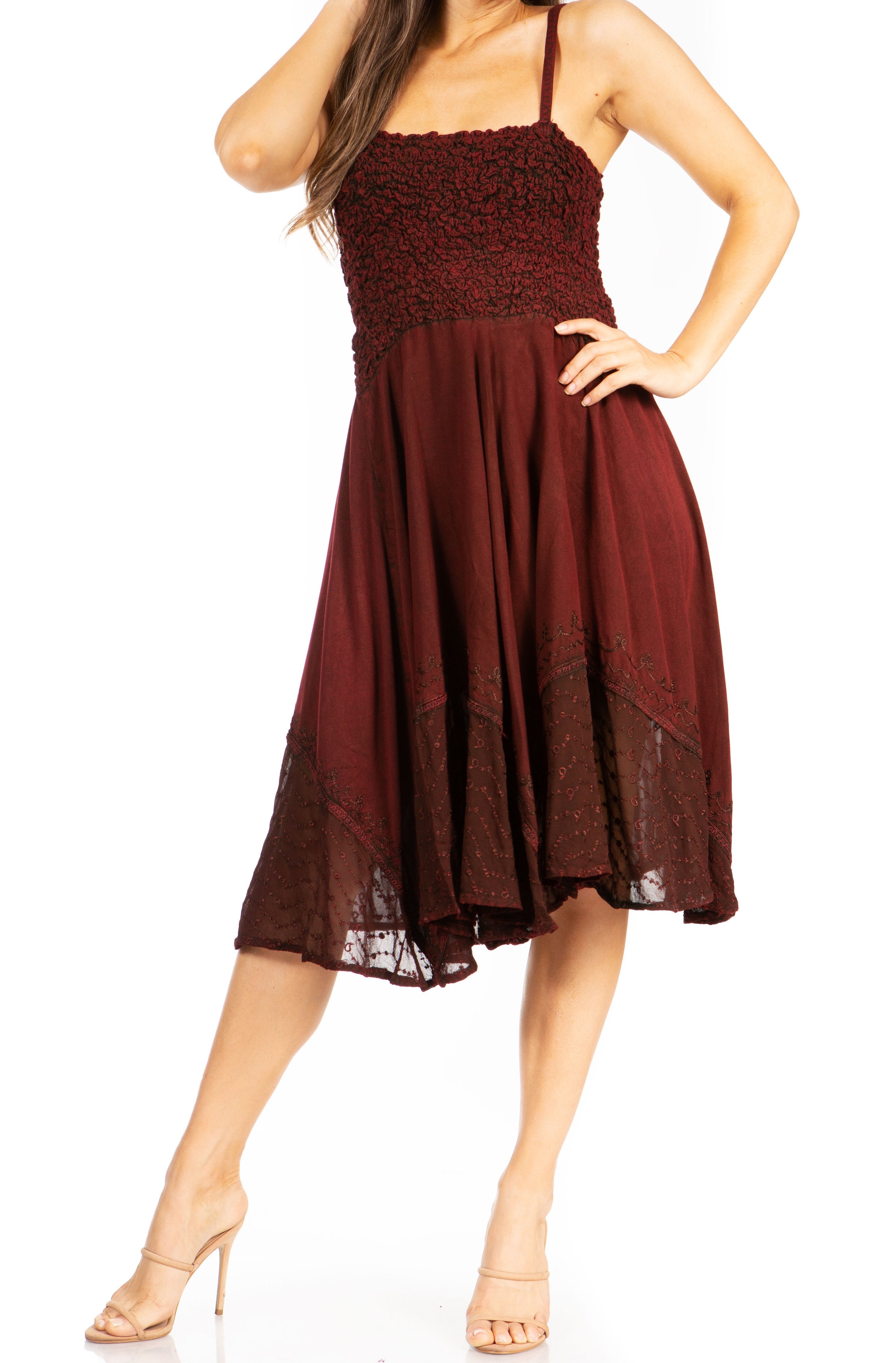 Woman wearing a burgundy dress with thin straps on a white background