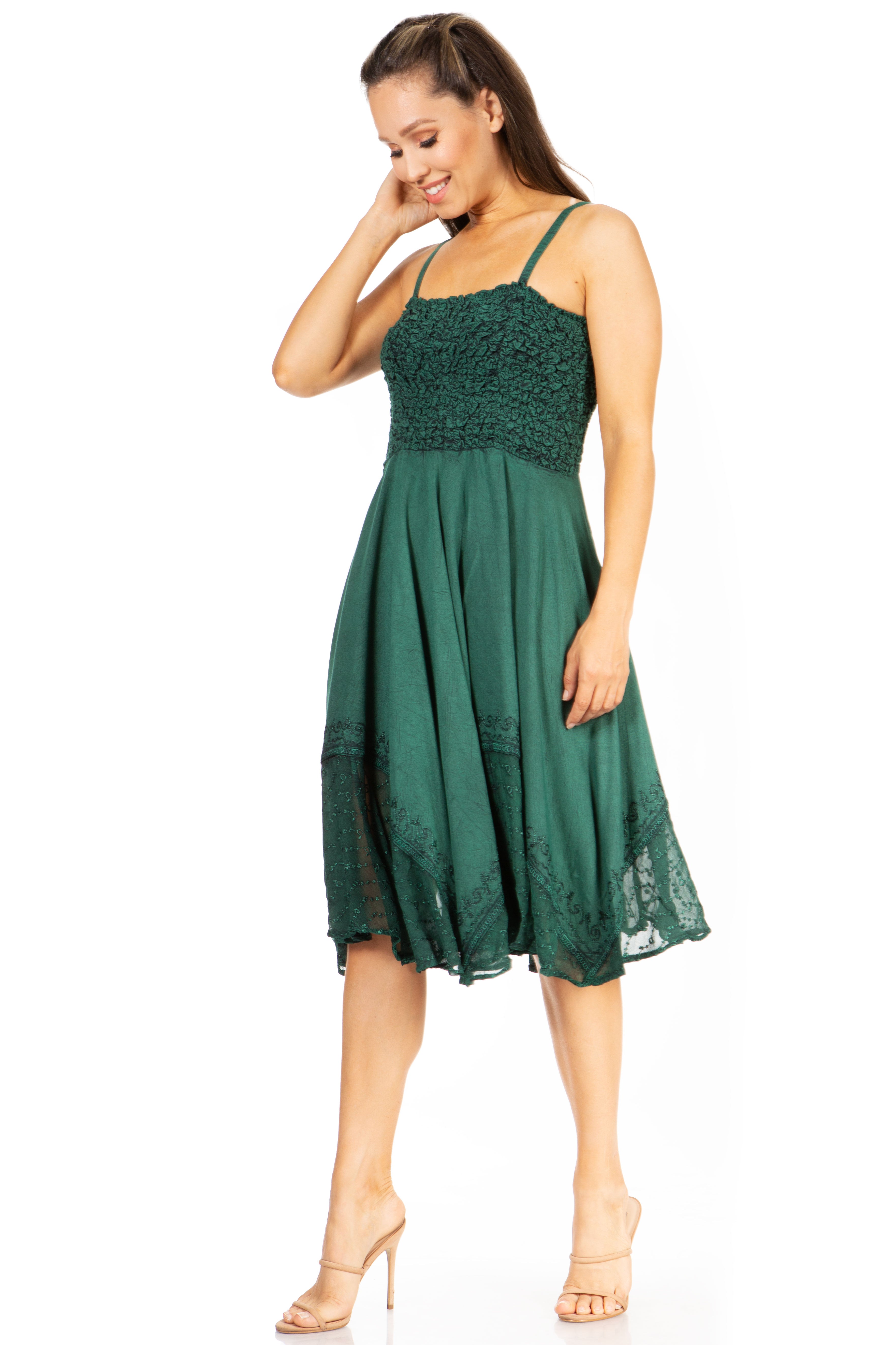 Woman wearing a green dress with lace details on a white background