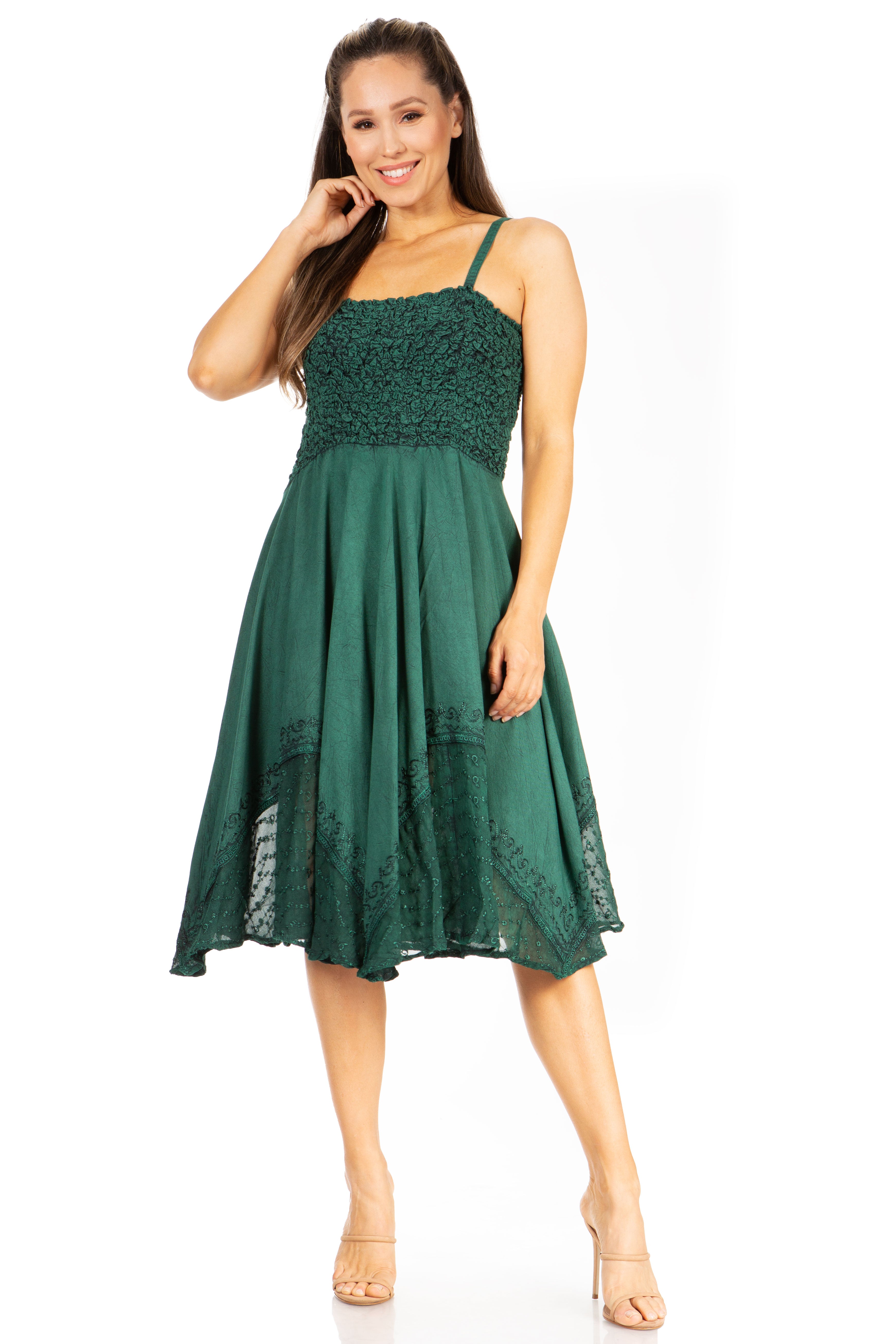 Woman wearing a green dress with lace details on a white background
