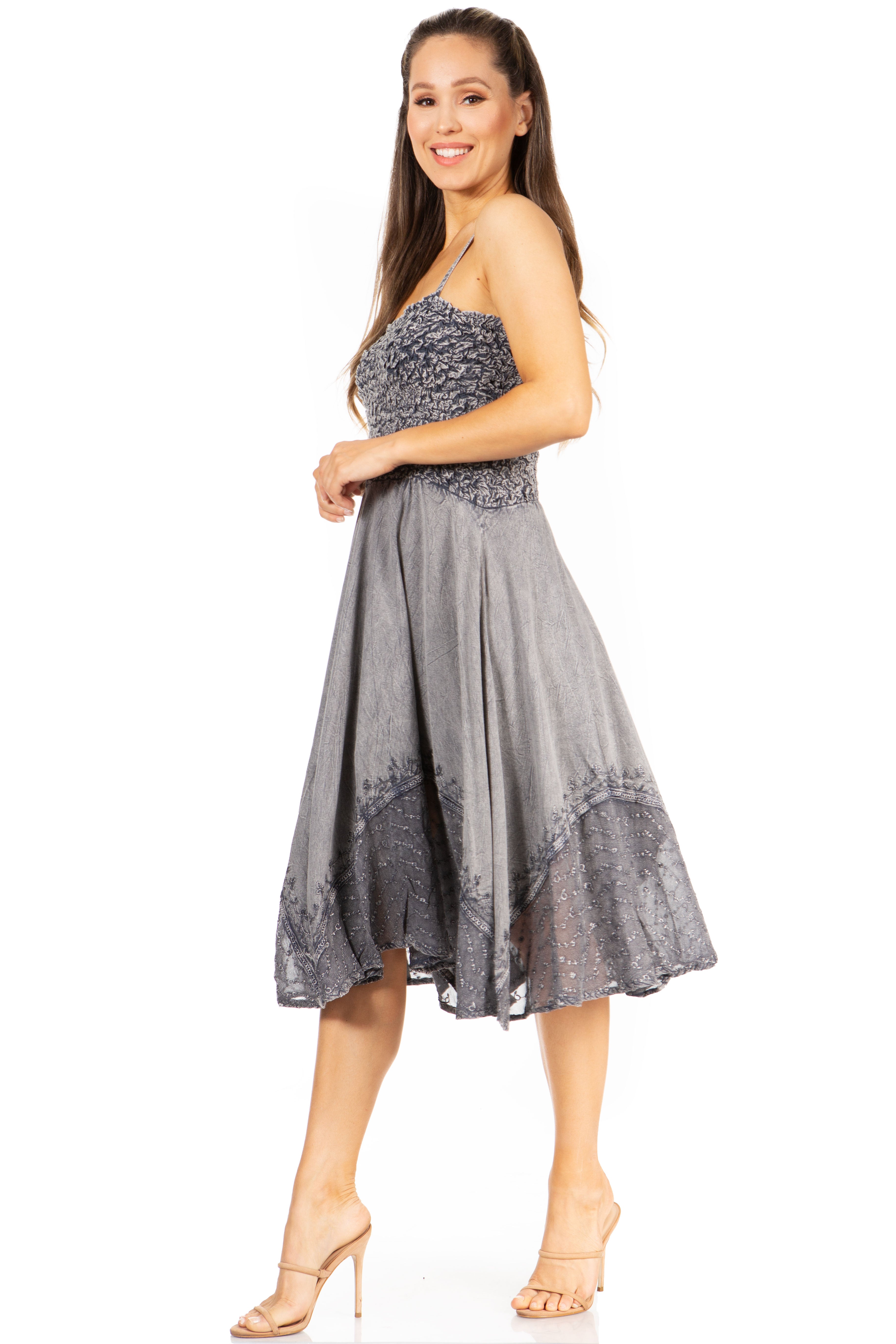 Woman wearing a gray dress with black floral patterns on a white background