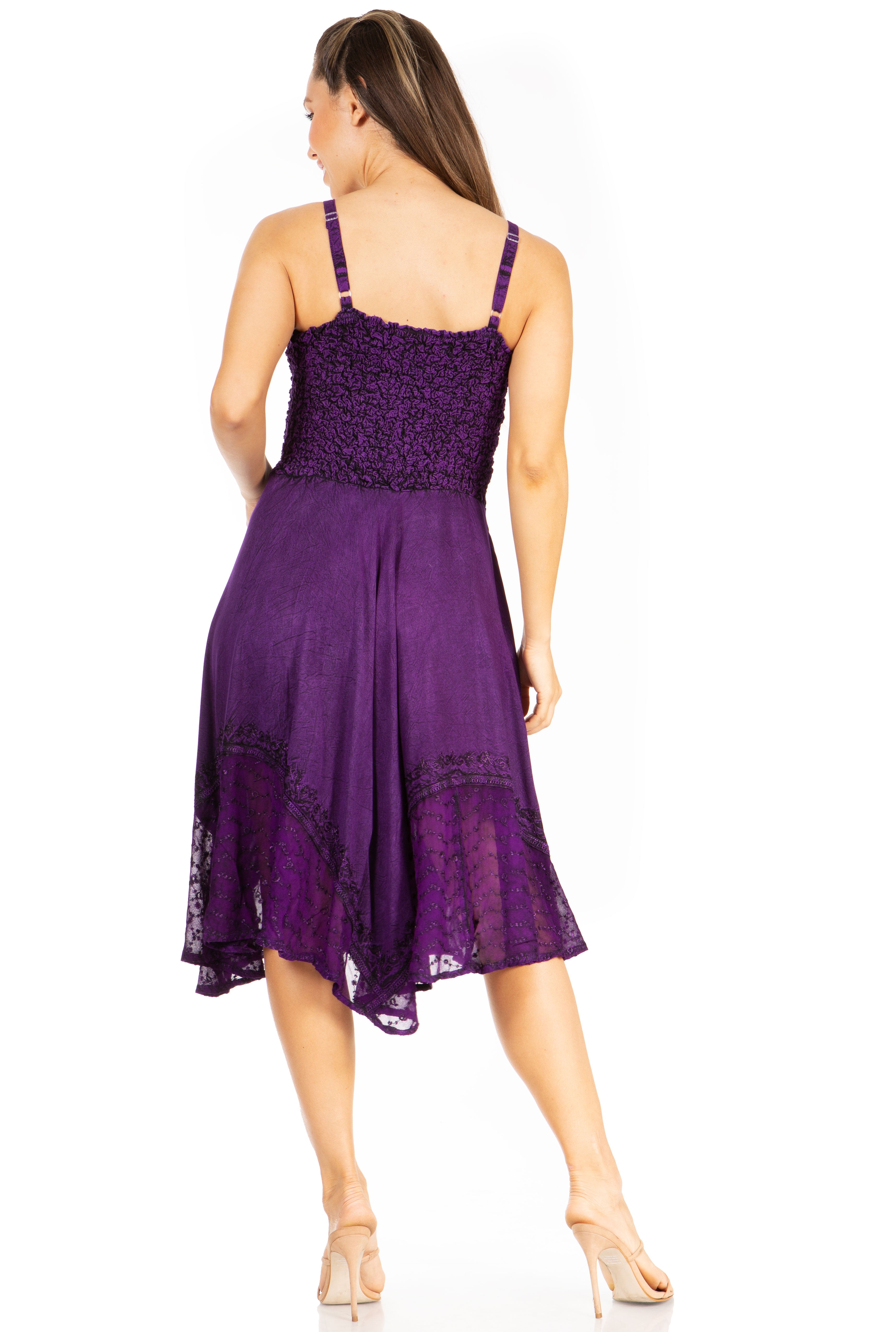 Woman wearing a purple dress with lace details on a white background