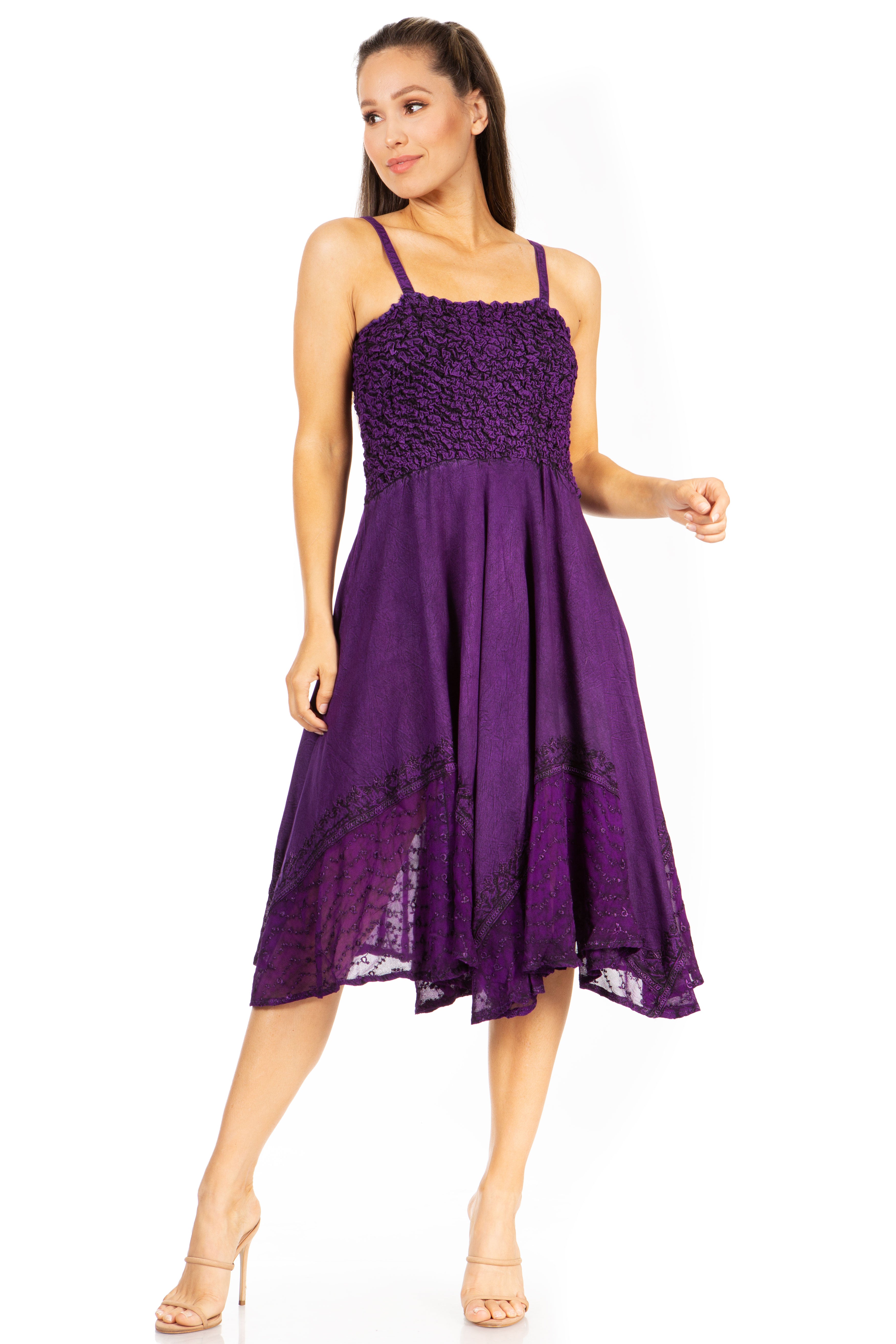 Woman wearing a purple dress with lace details on a white background