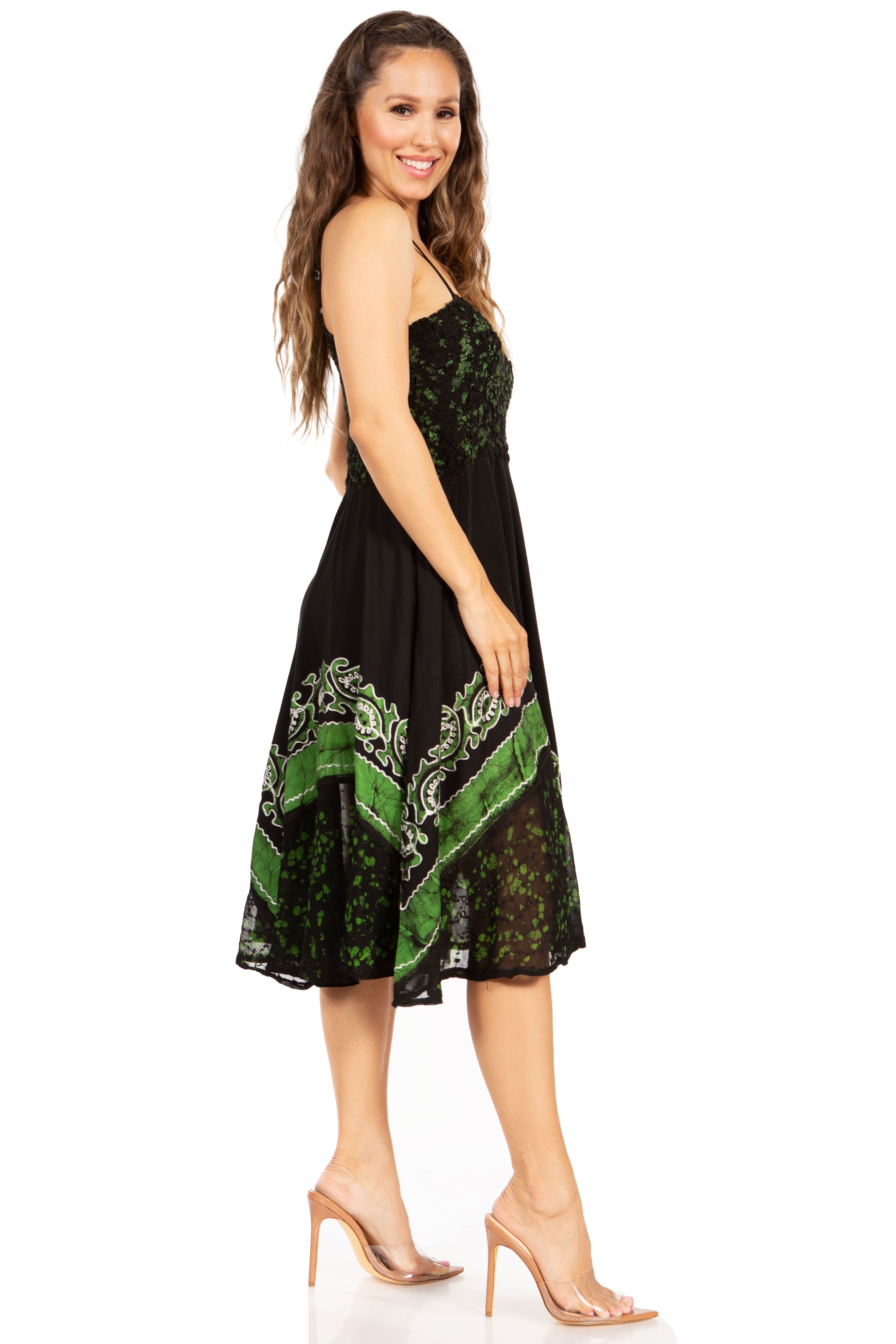 Woman wearing a black dress with green pattern on a white background