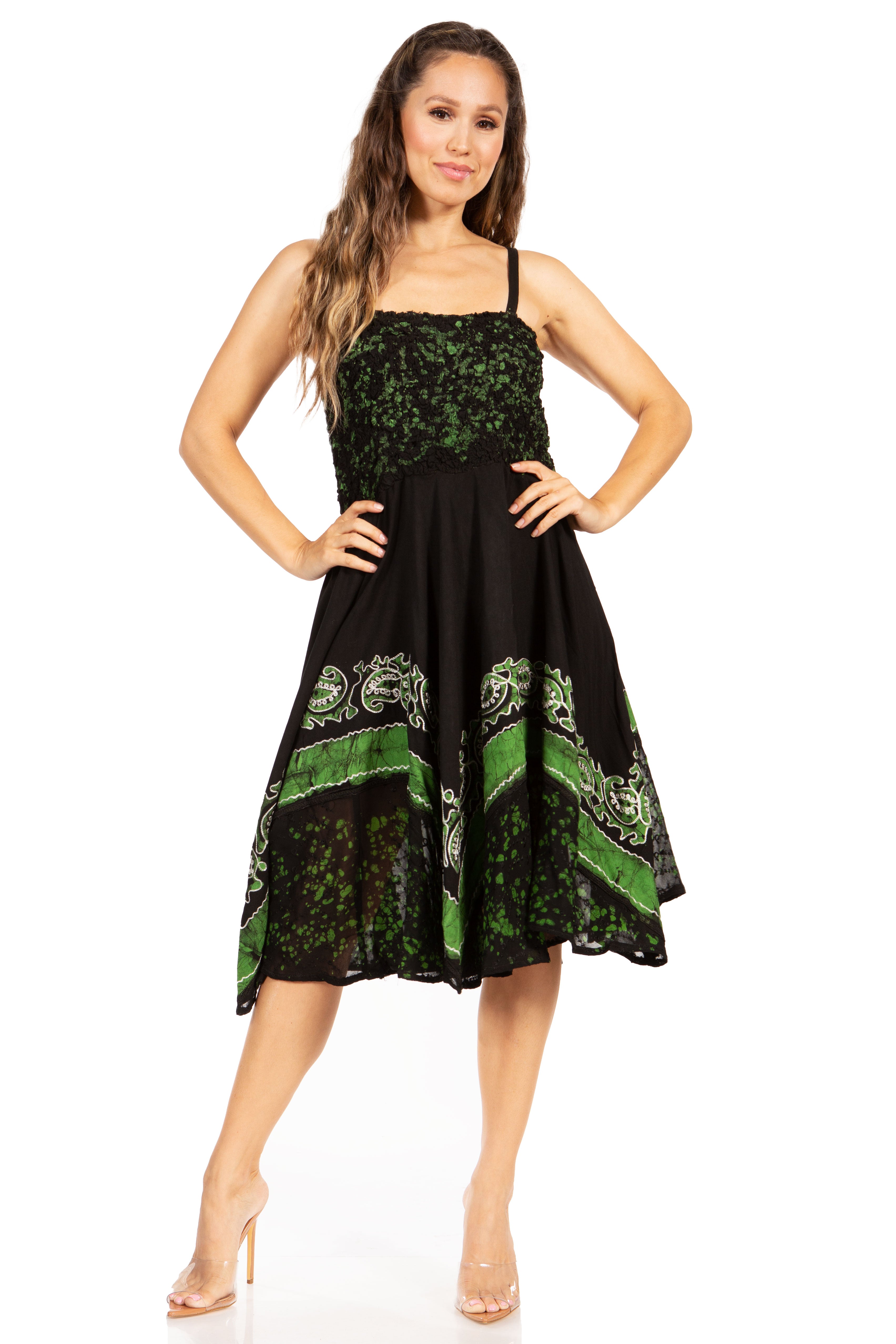 Woman wearing a black dress with green floral patterns on a white background