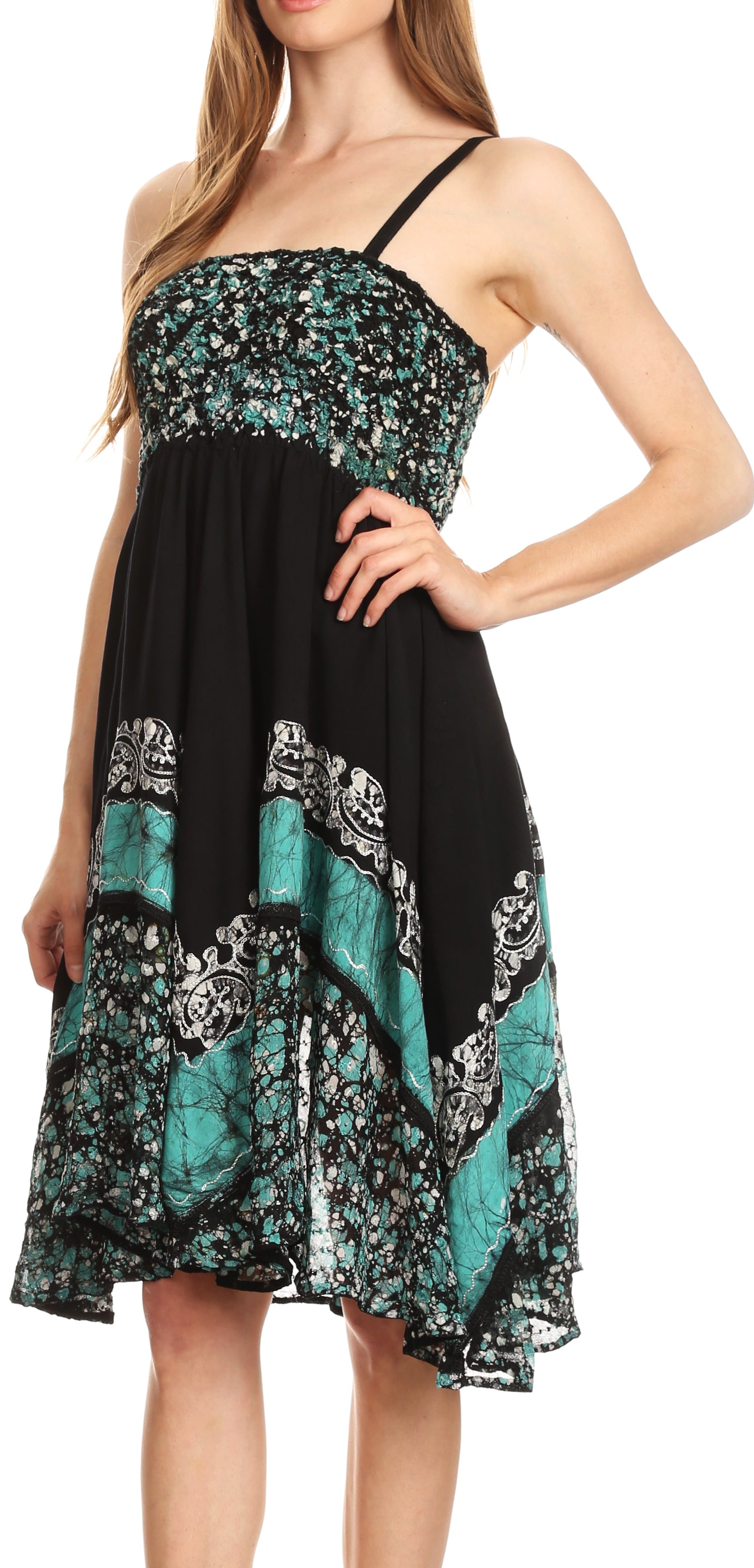 Woman wearing a black and teal patterned dress on a white background