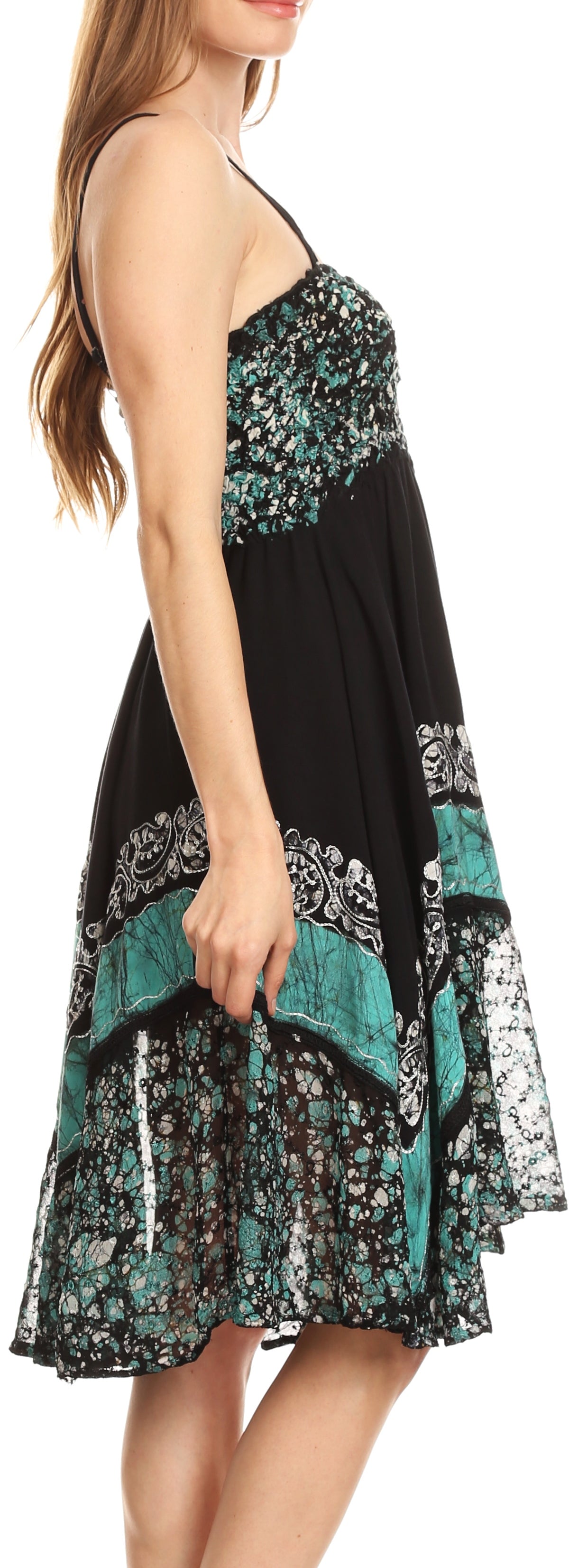 Woman wearing a black and teal patterned dress on a white background
