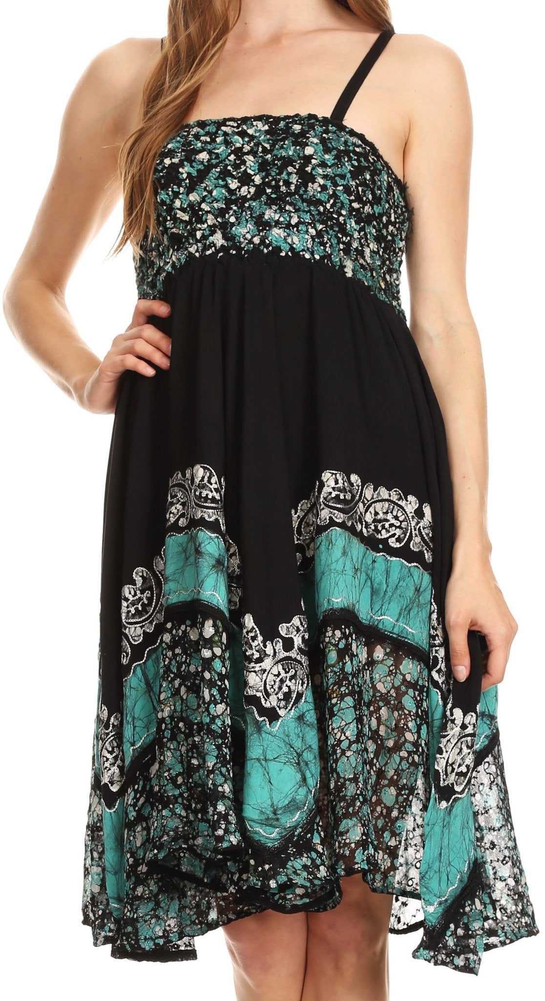 Black and teal patterned dress worn by a model on a white background