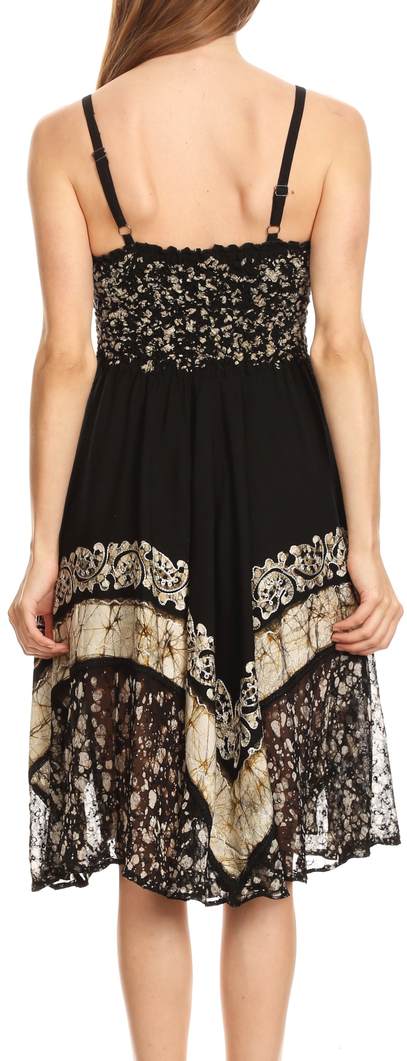 Black lace dress with beige floral patterns on a white background