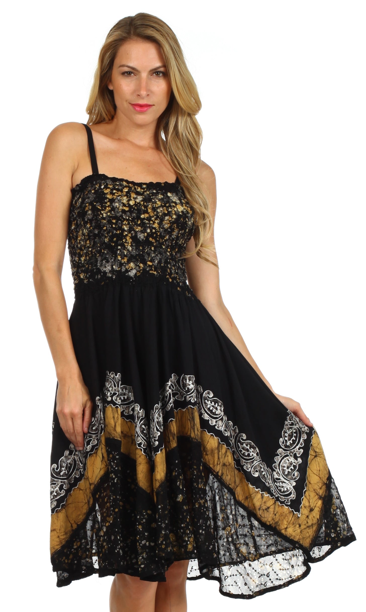 Woman wearing a black and gold dress with intricate patterns on a white background
