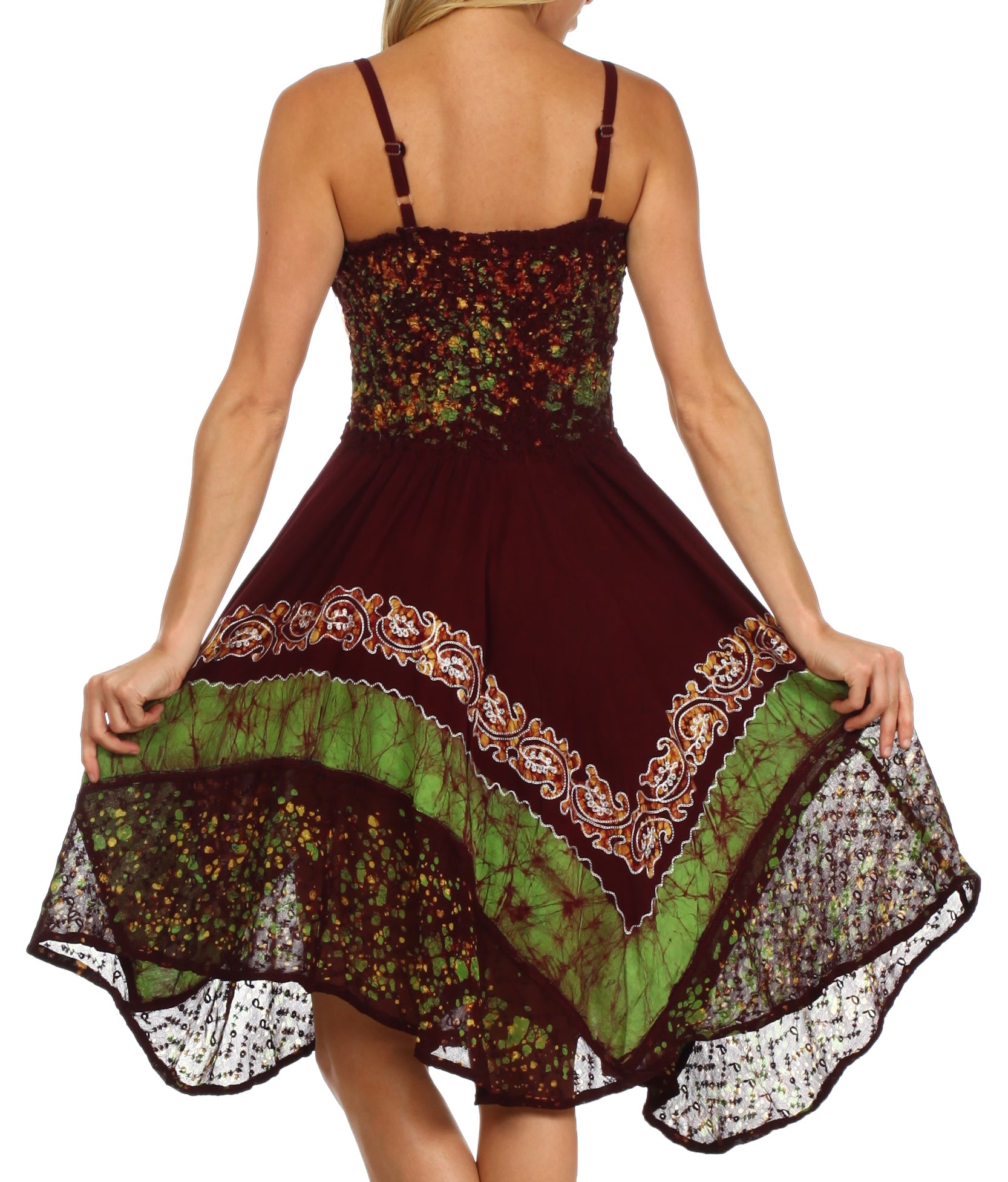 Woman wearing a colorful dress with intricate patterns on a white background