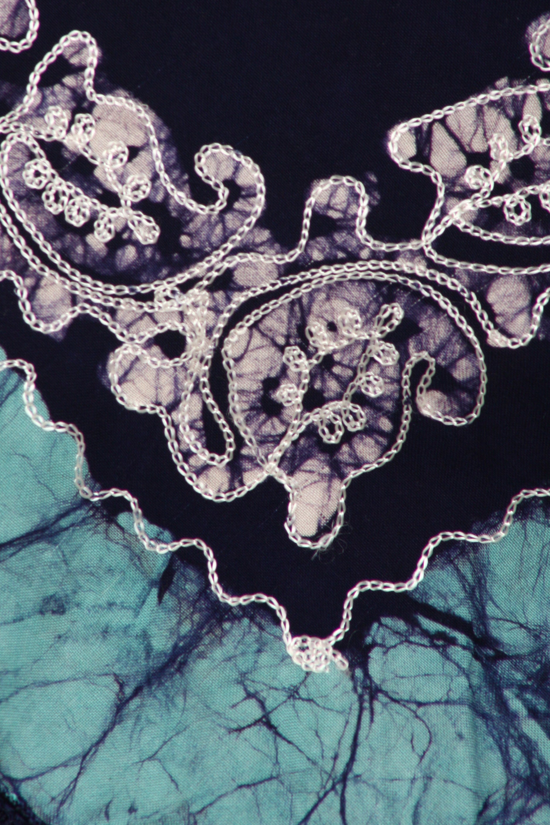 Decorative lace with a black and blue abstract pattern in the background