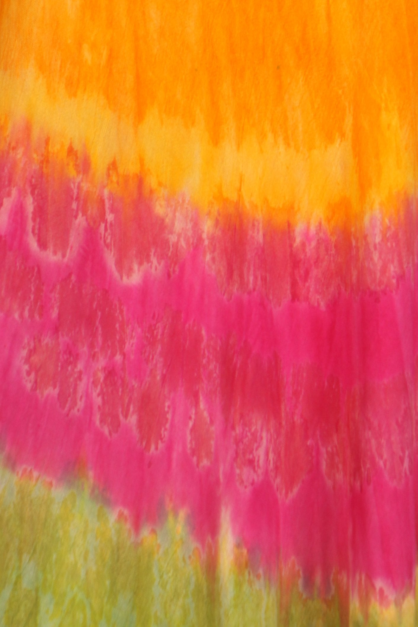 Colorful tie-dye pattern with orange, pink, and green hues.
