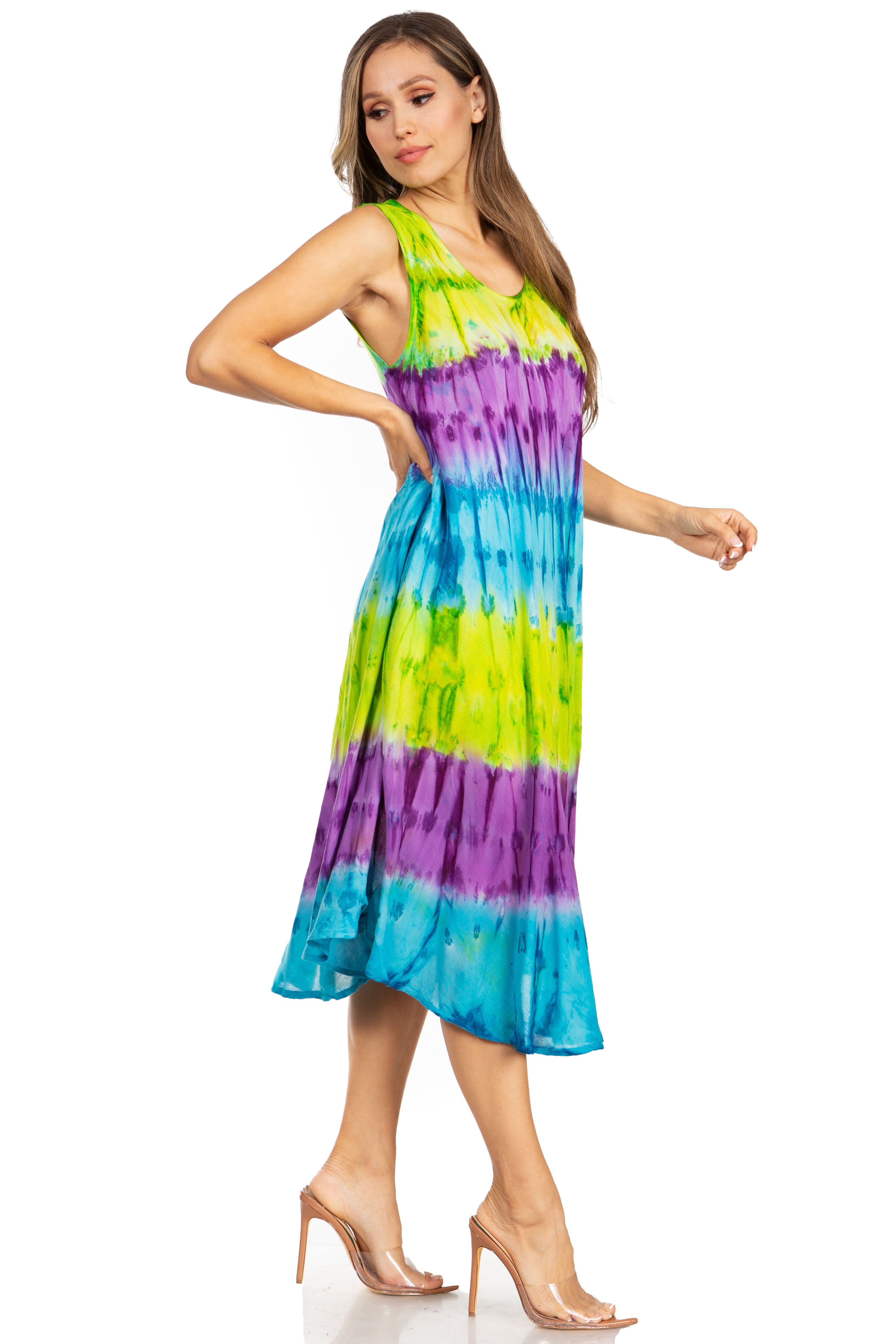 Woman wearing a tie-dye dress with green, blue, and purple colors on a white background