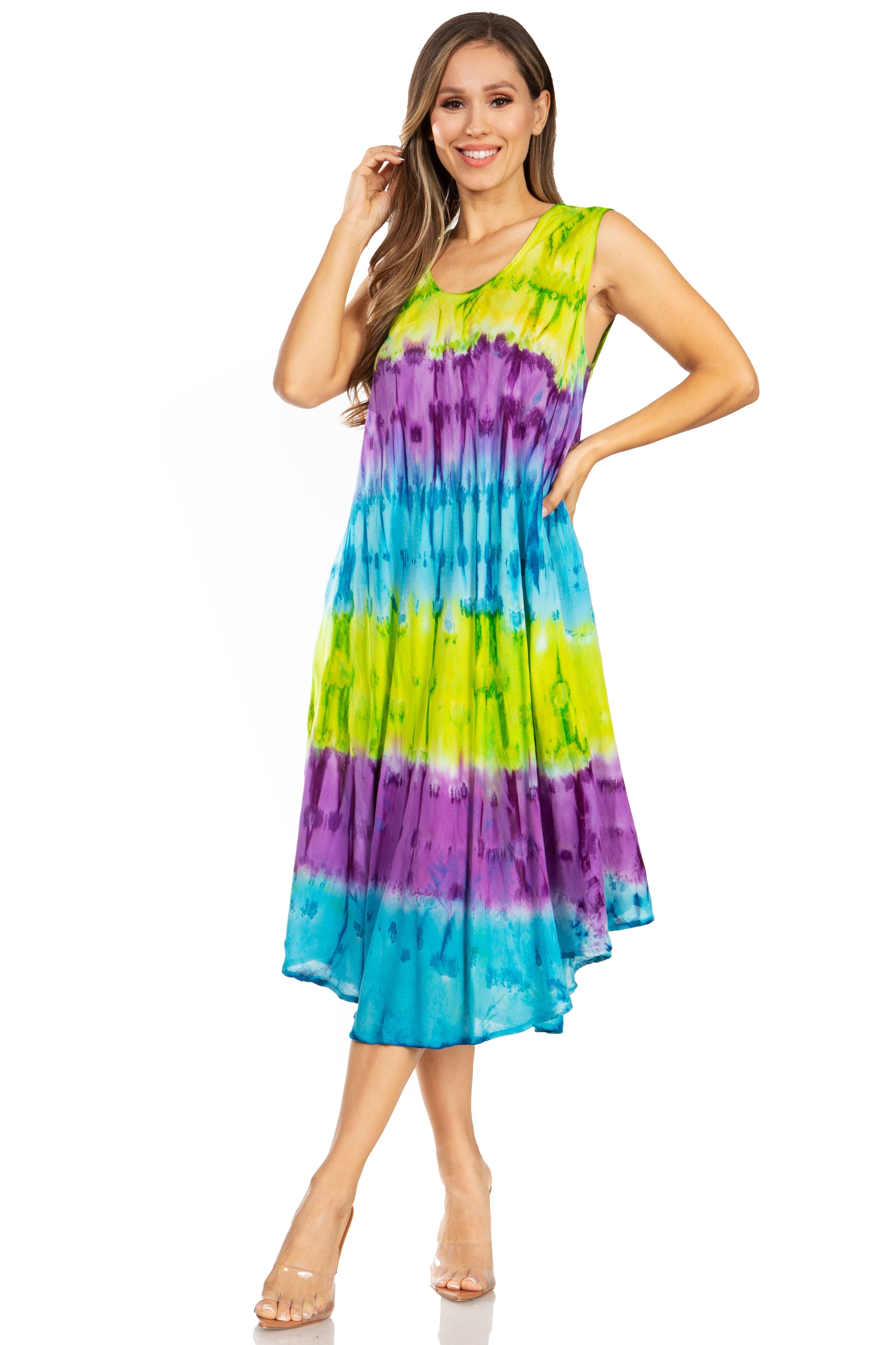 Woman wearing a tie-dye dress with green, purple, and blue colors on a white background