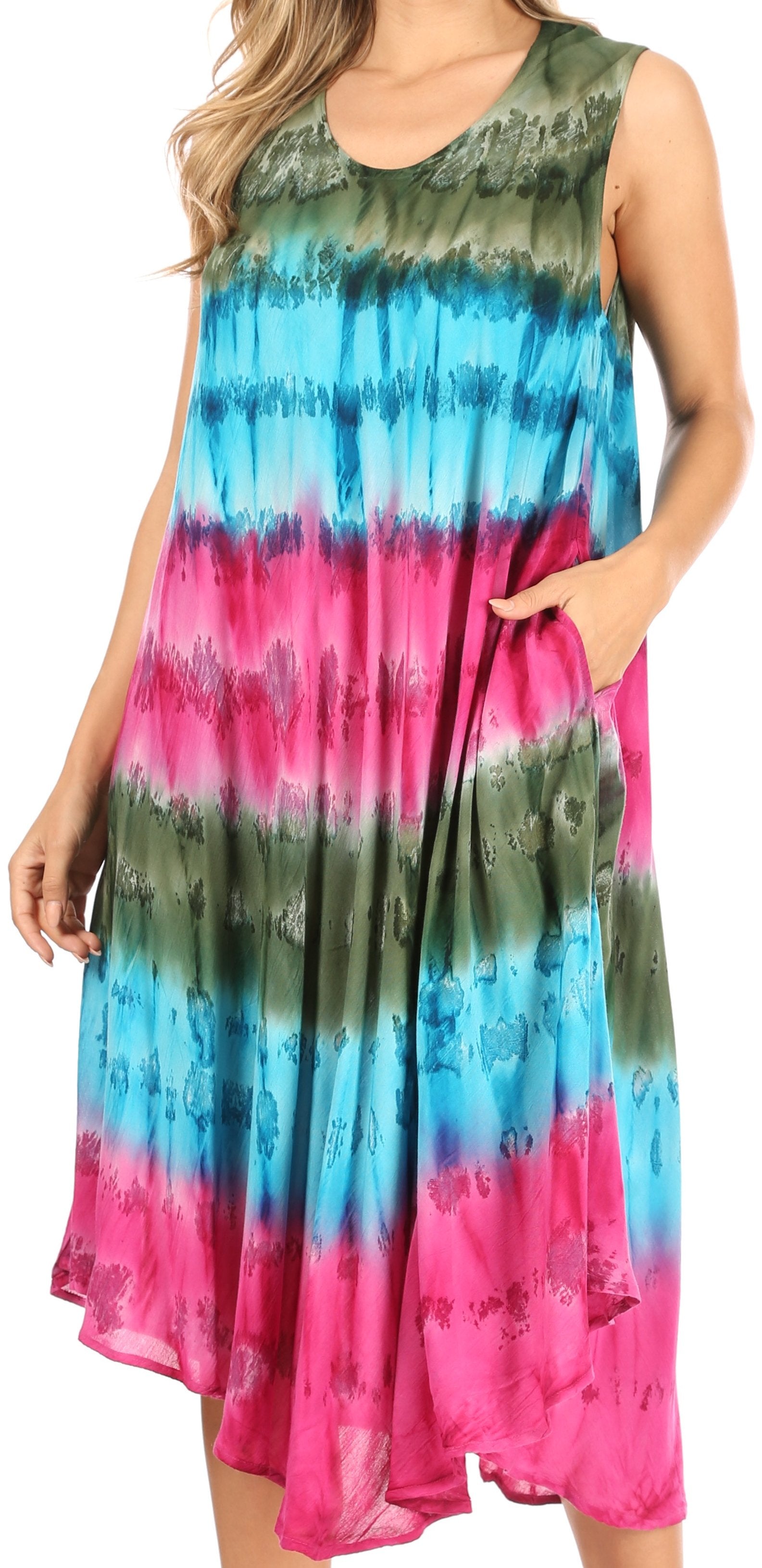 Woman wearing a tie-dye dress with green, blue, and pink colors.