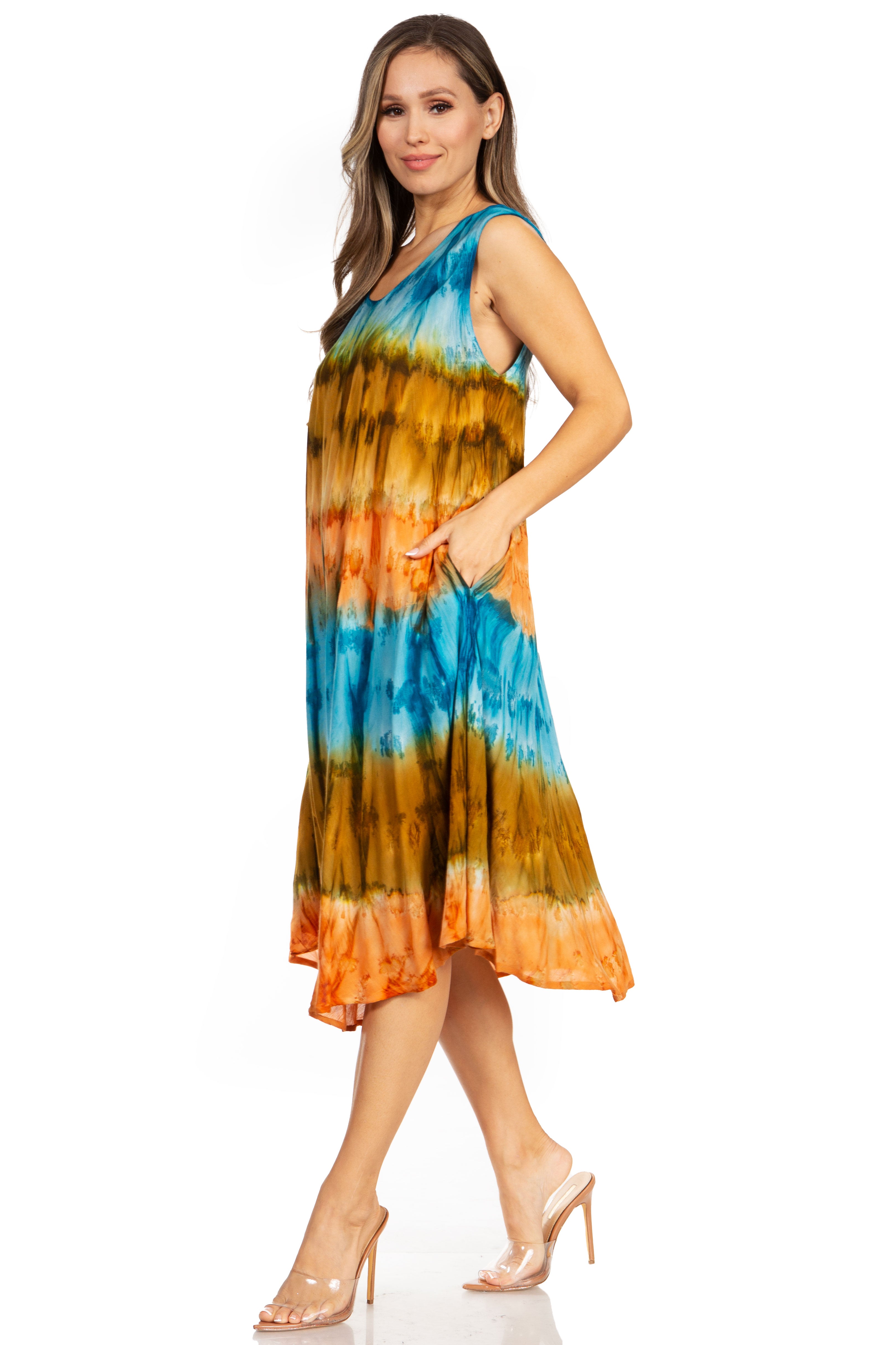 Woman wearing a tie-dye dress with blue, orange, and green colors on a white background