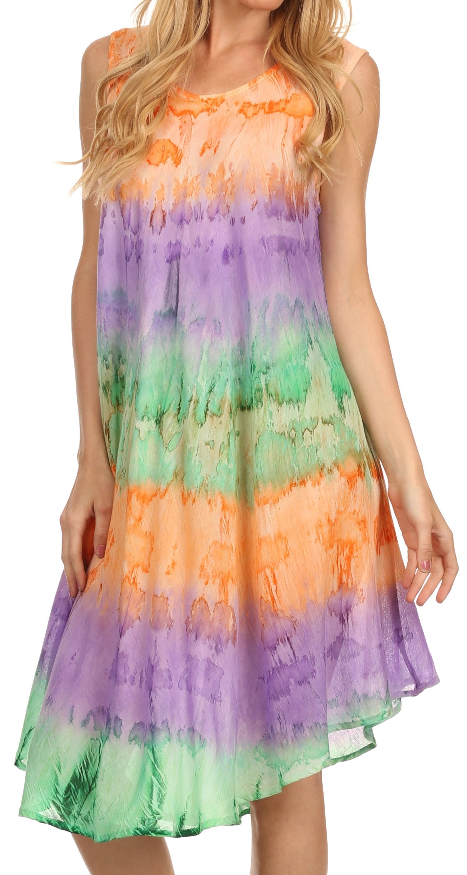 Woman wearing a tie-dye dress with orange, purple, and green colors on a white background.