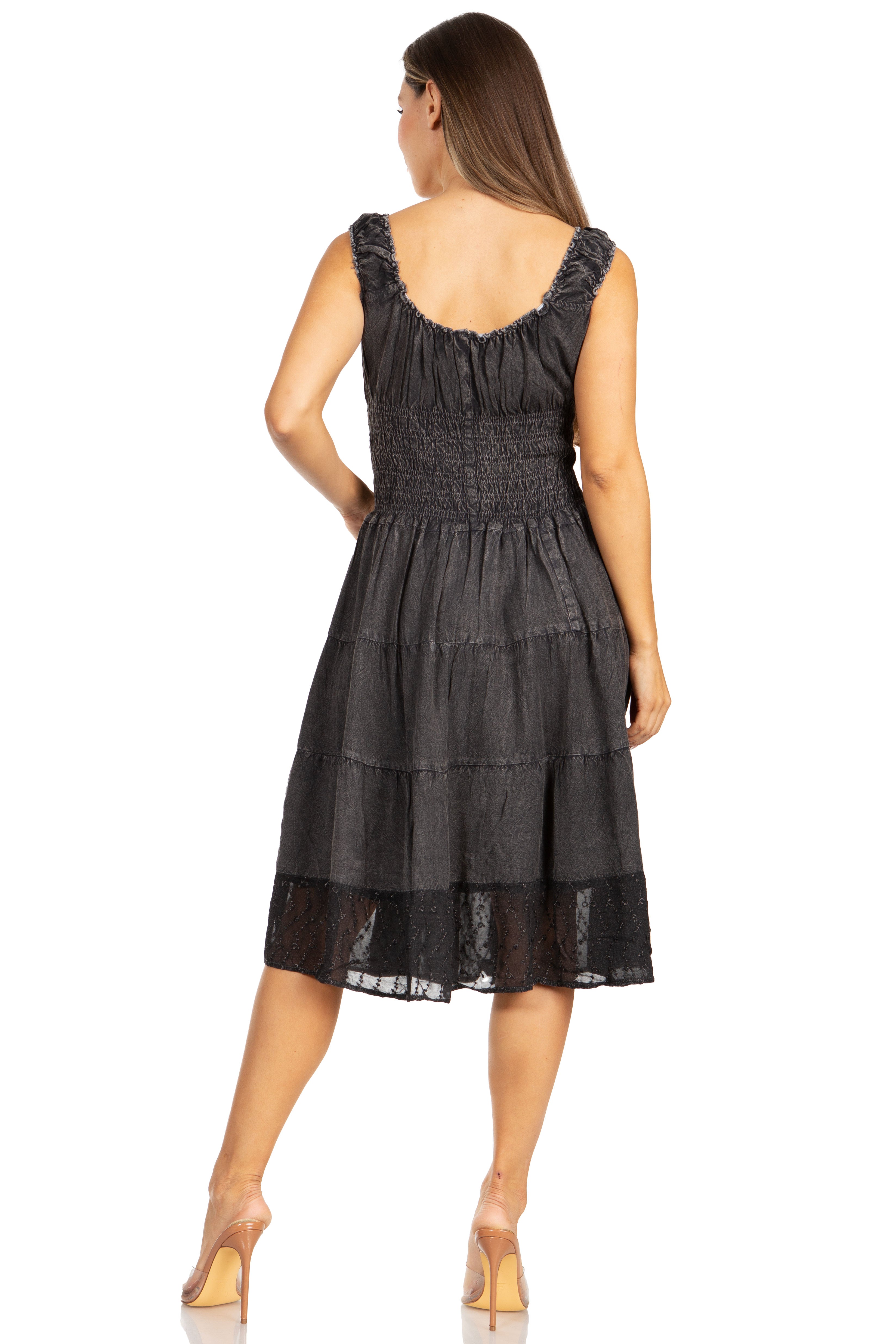 Woman wearing a black dress with ruffled straps on a white background