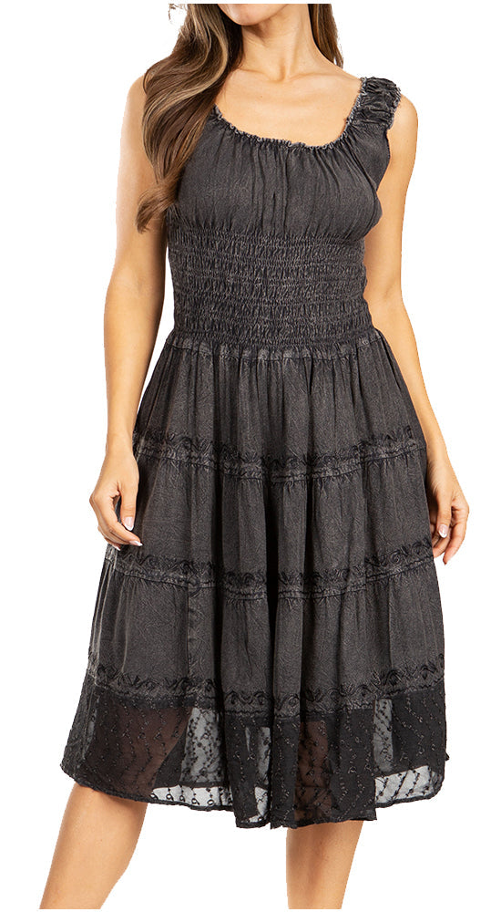 Black smocked dress with lace details on a white background
