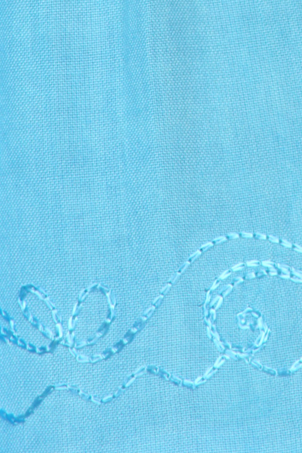 Close-up of a blue fabric with decorative stitching