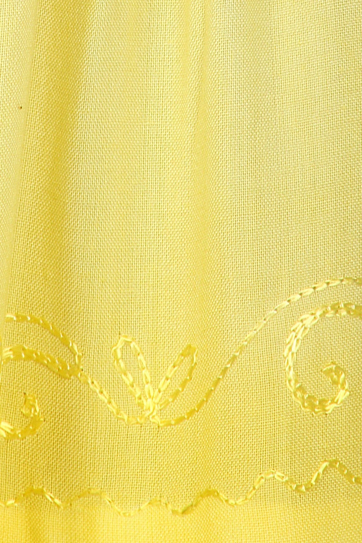 Close-up of yellow fabric with decorative stitching