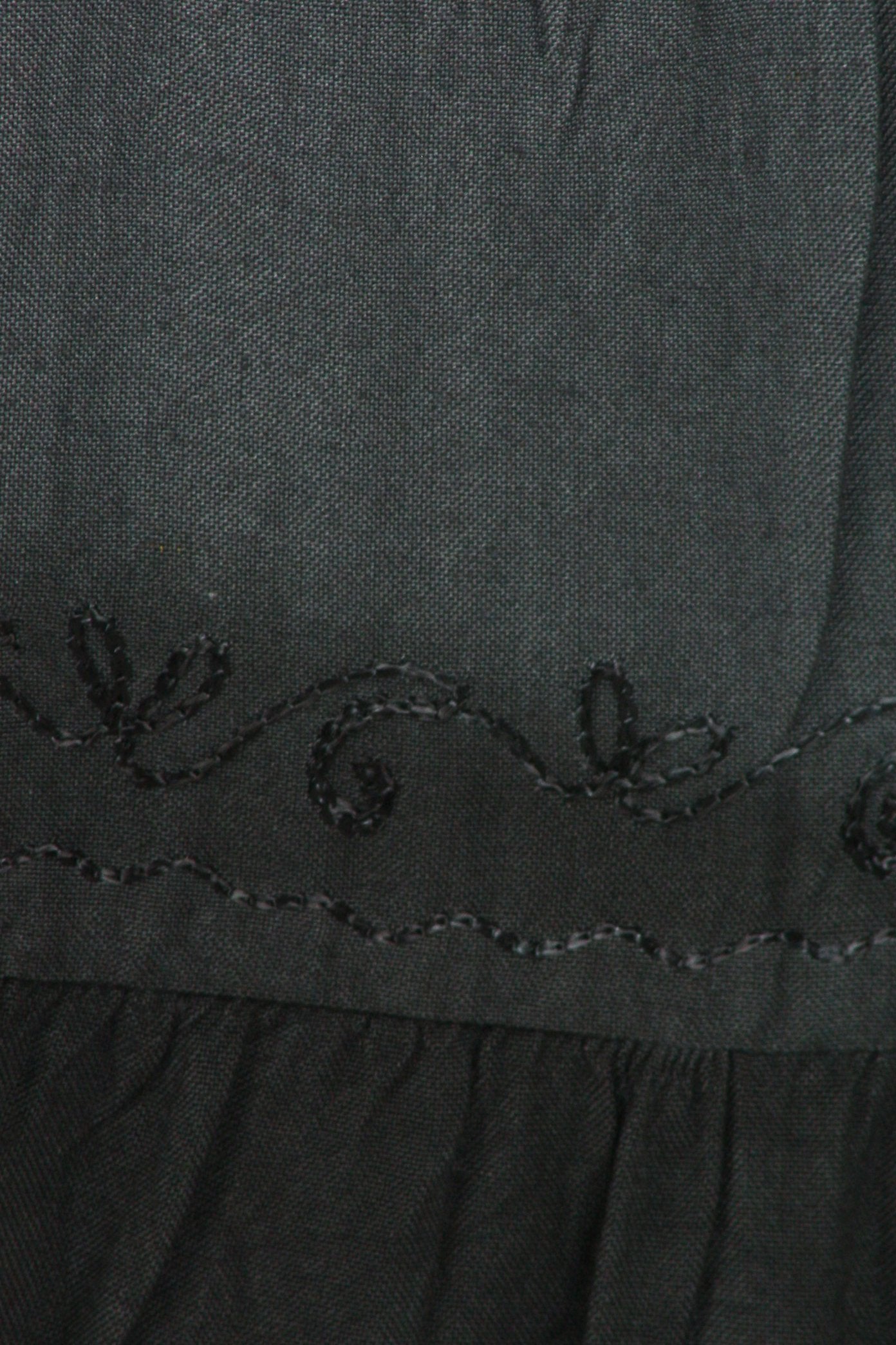 Close-up of a dark gray fabric with embroidered details