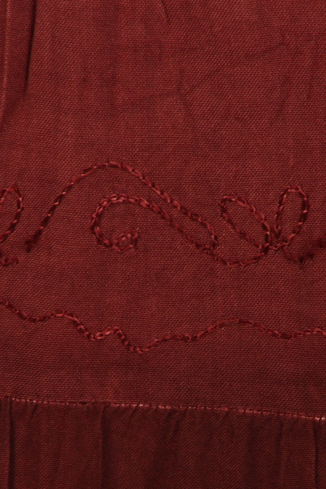 Close-up of a red fabric with embroidered pattern