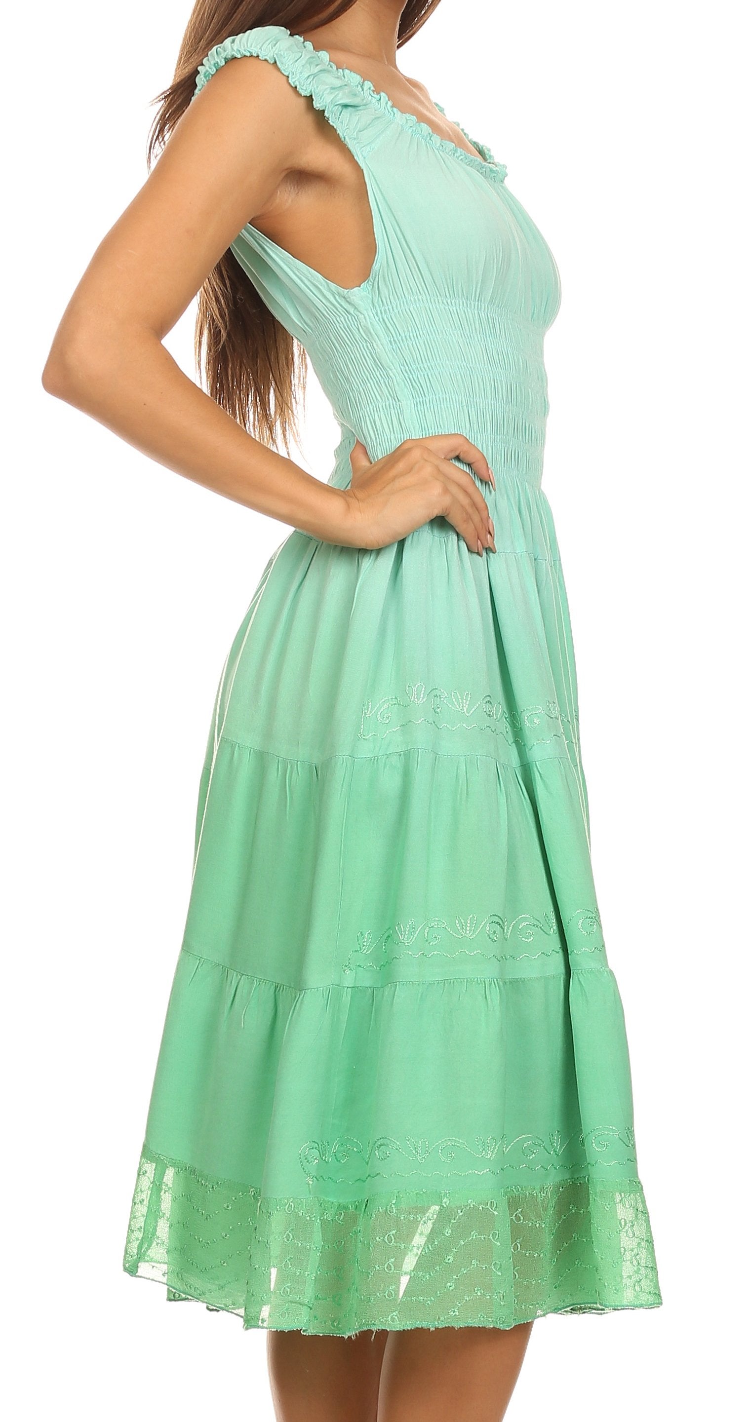 Mint green dress with lace details on a white background
