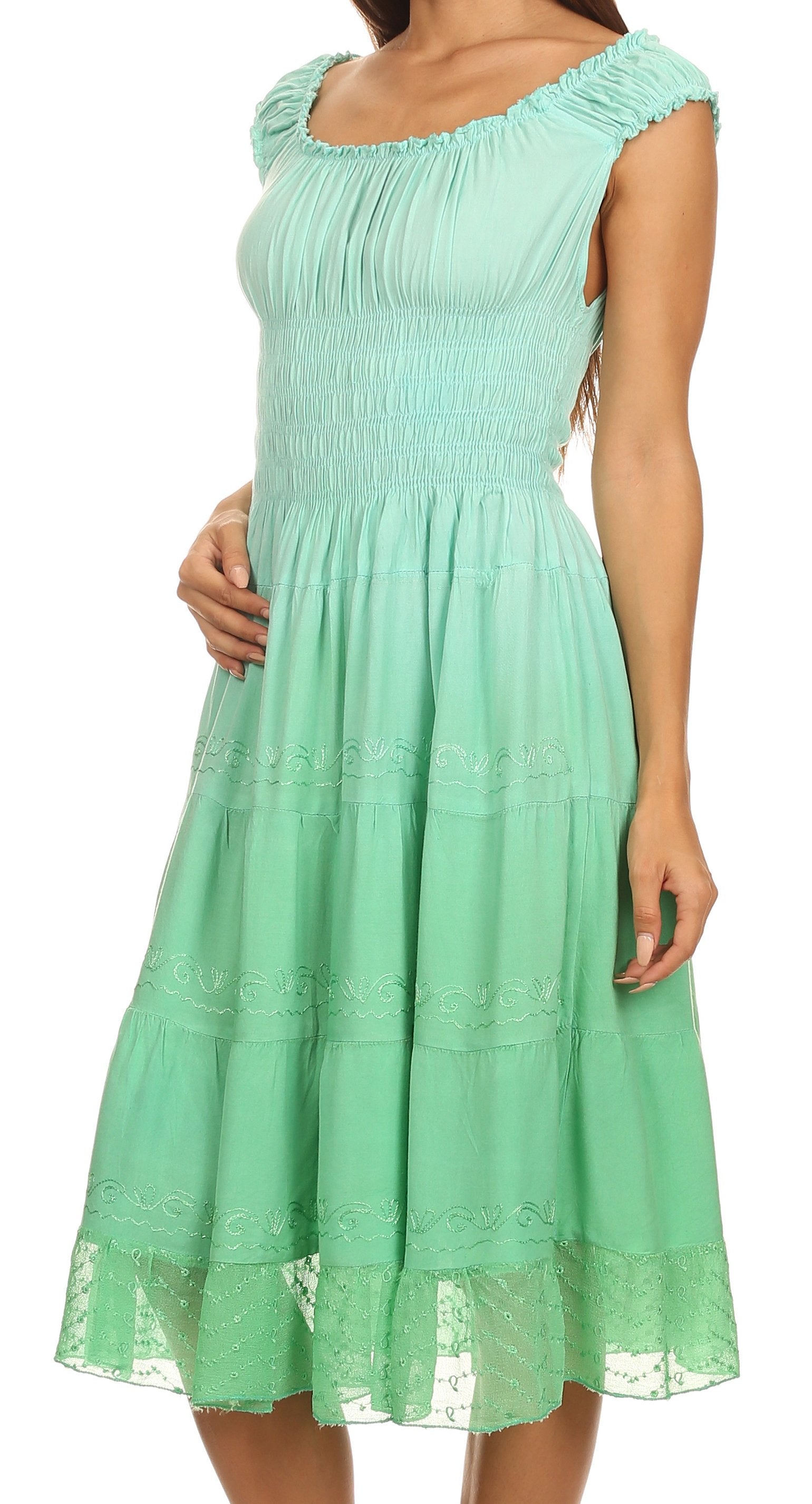 Mint green dress with lace trim on a white background