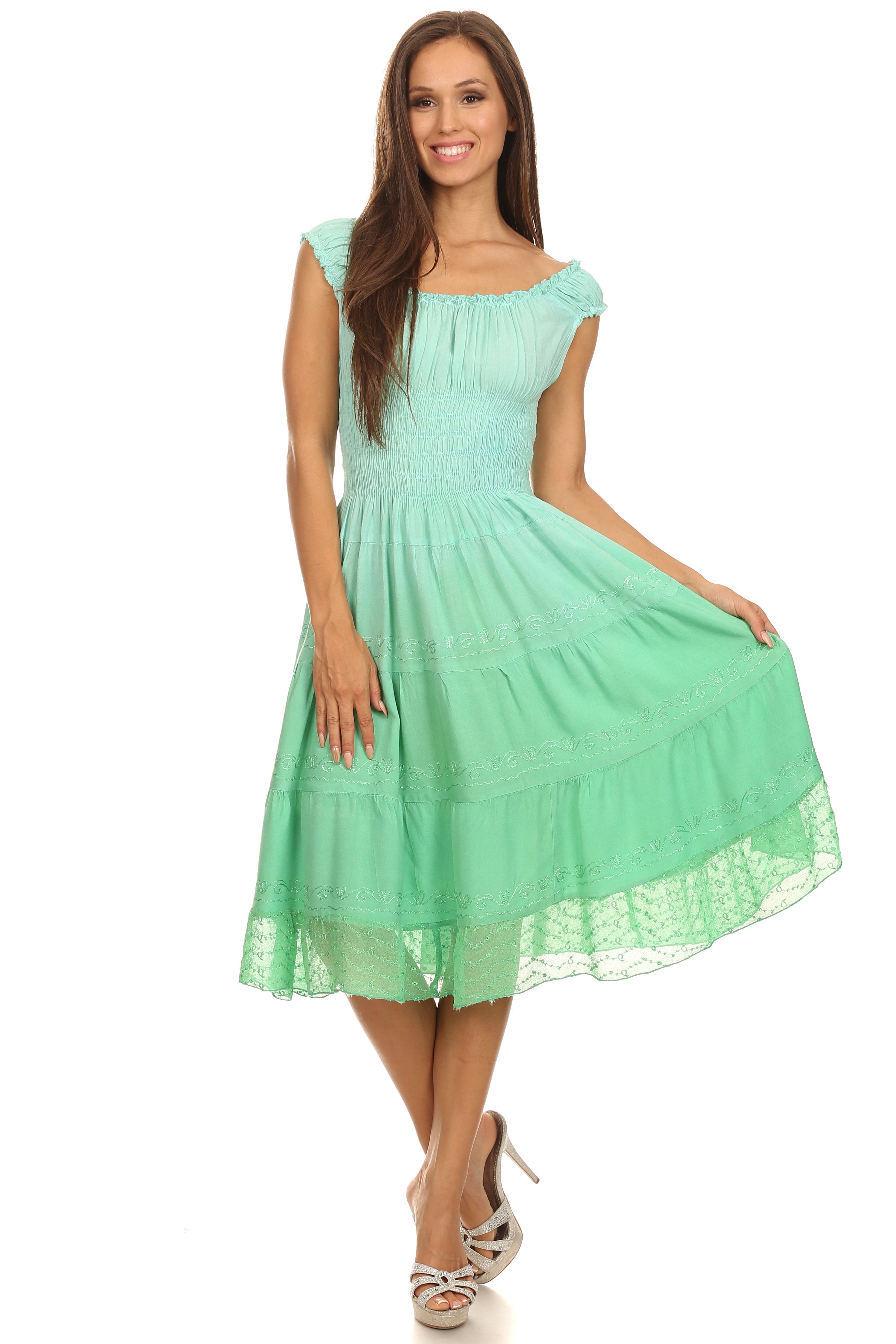 Woman wearing a light green dress on a white background