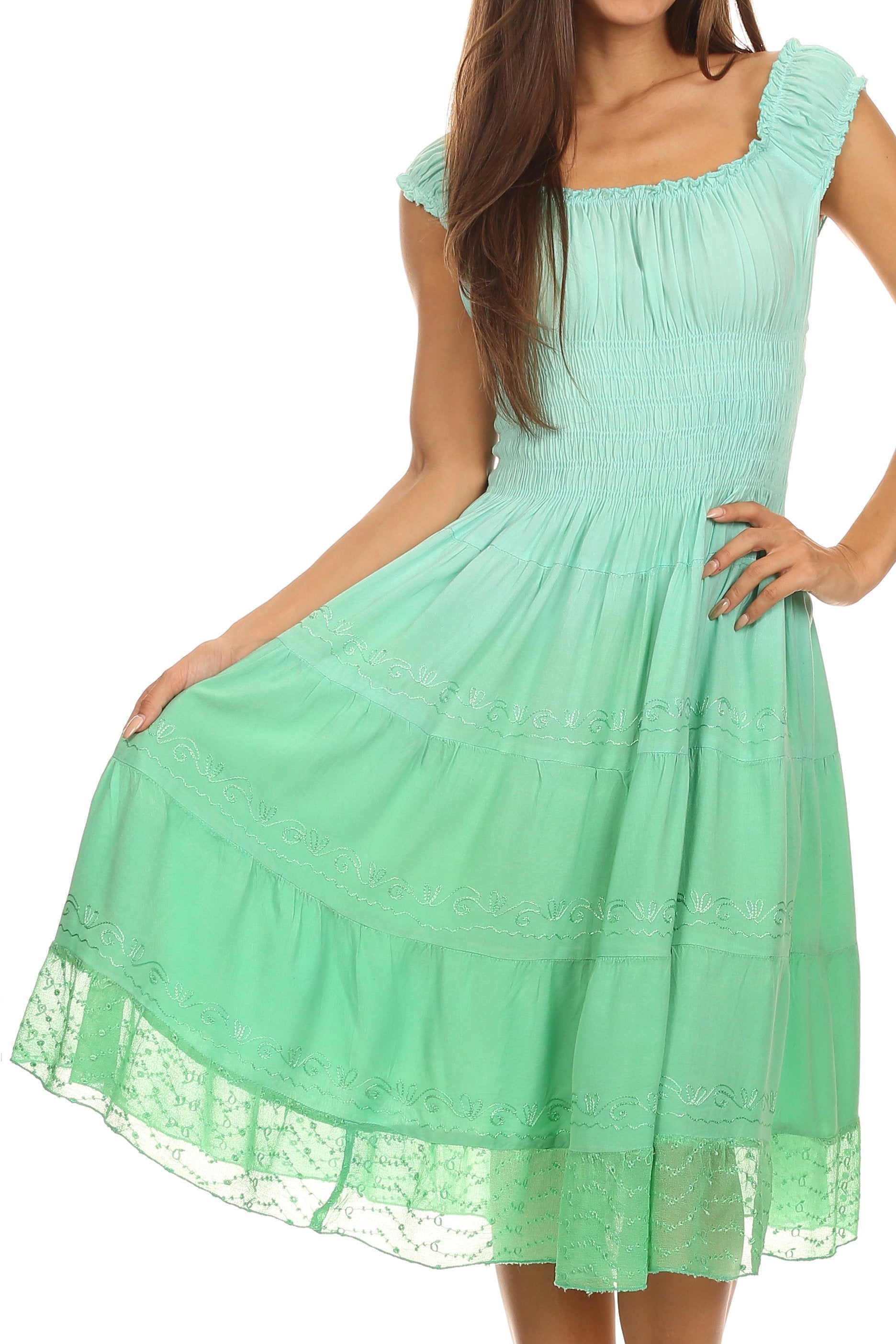 Mint green dress with lace details on a white background