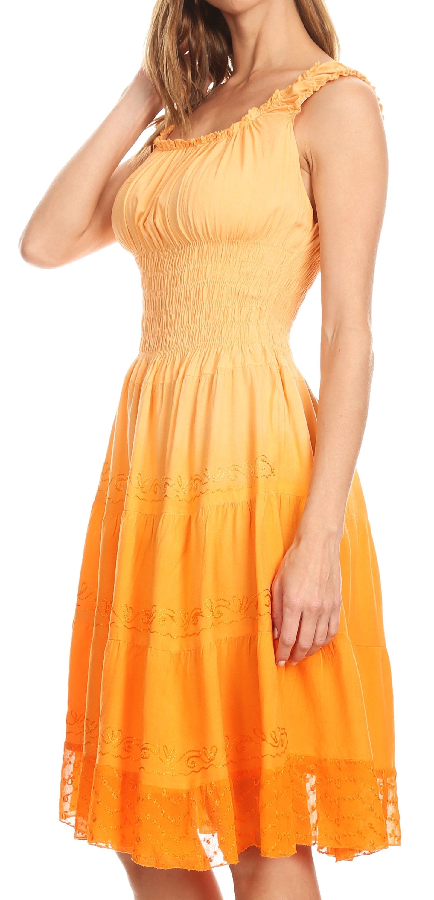 Woman wearing an orange dress with lace details on a white background