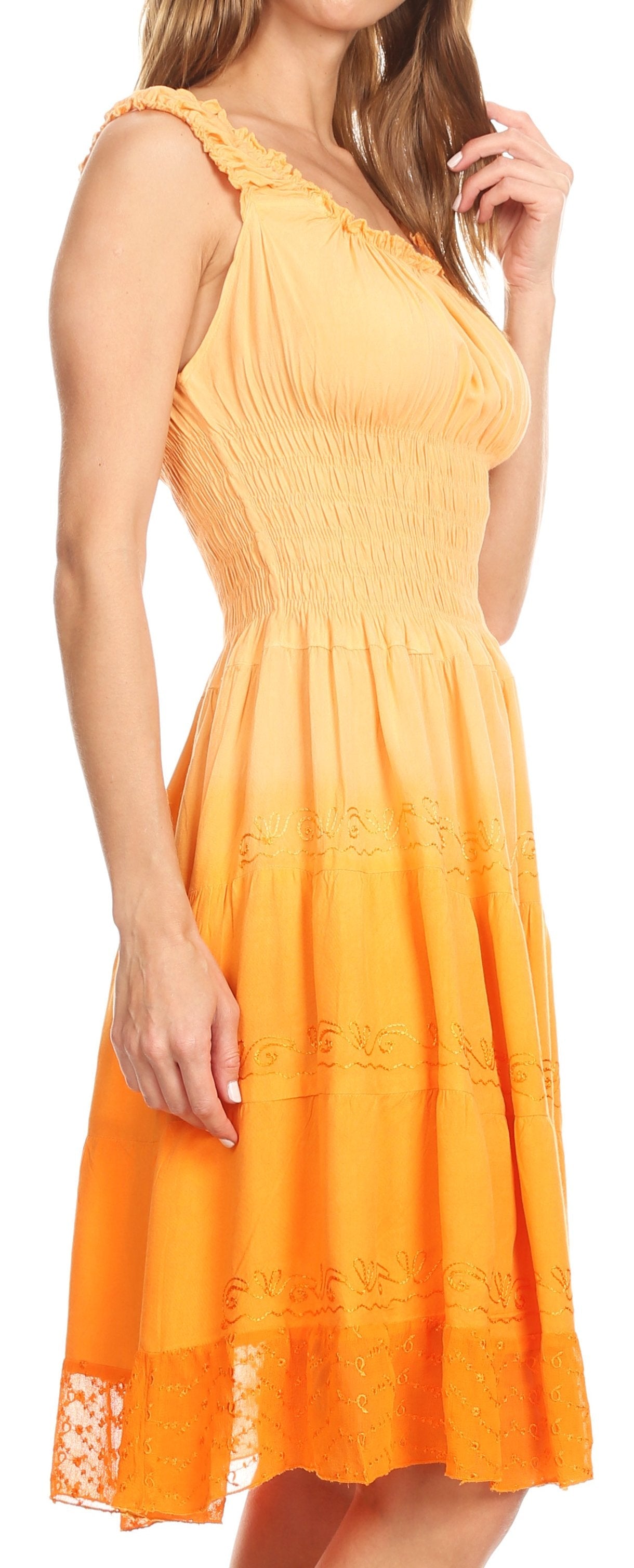 Woman wearing a yellow dress with lace details on a white background