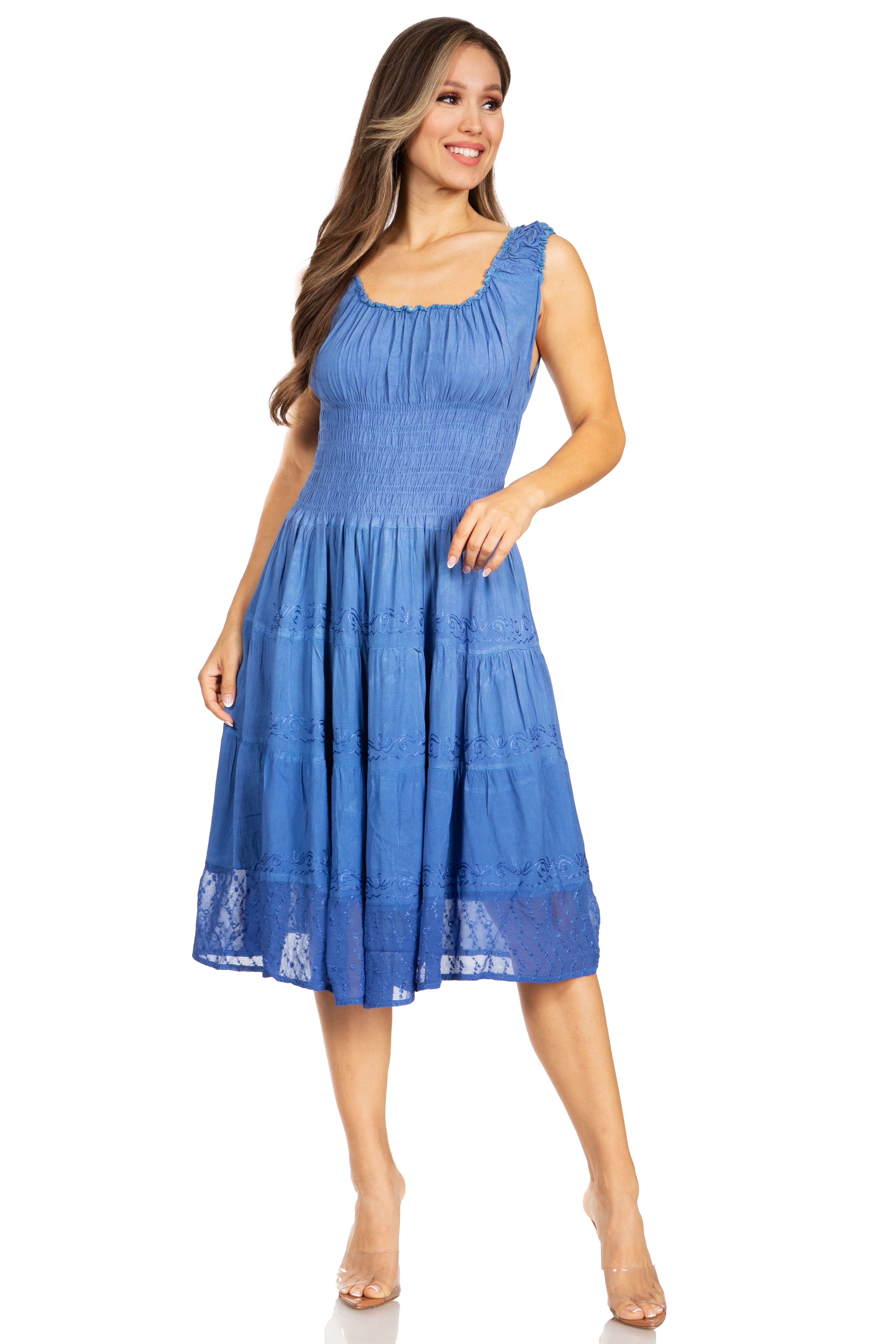 Woman wearing a blue dress with lace details on a white background