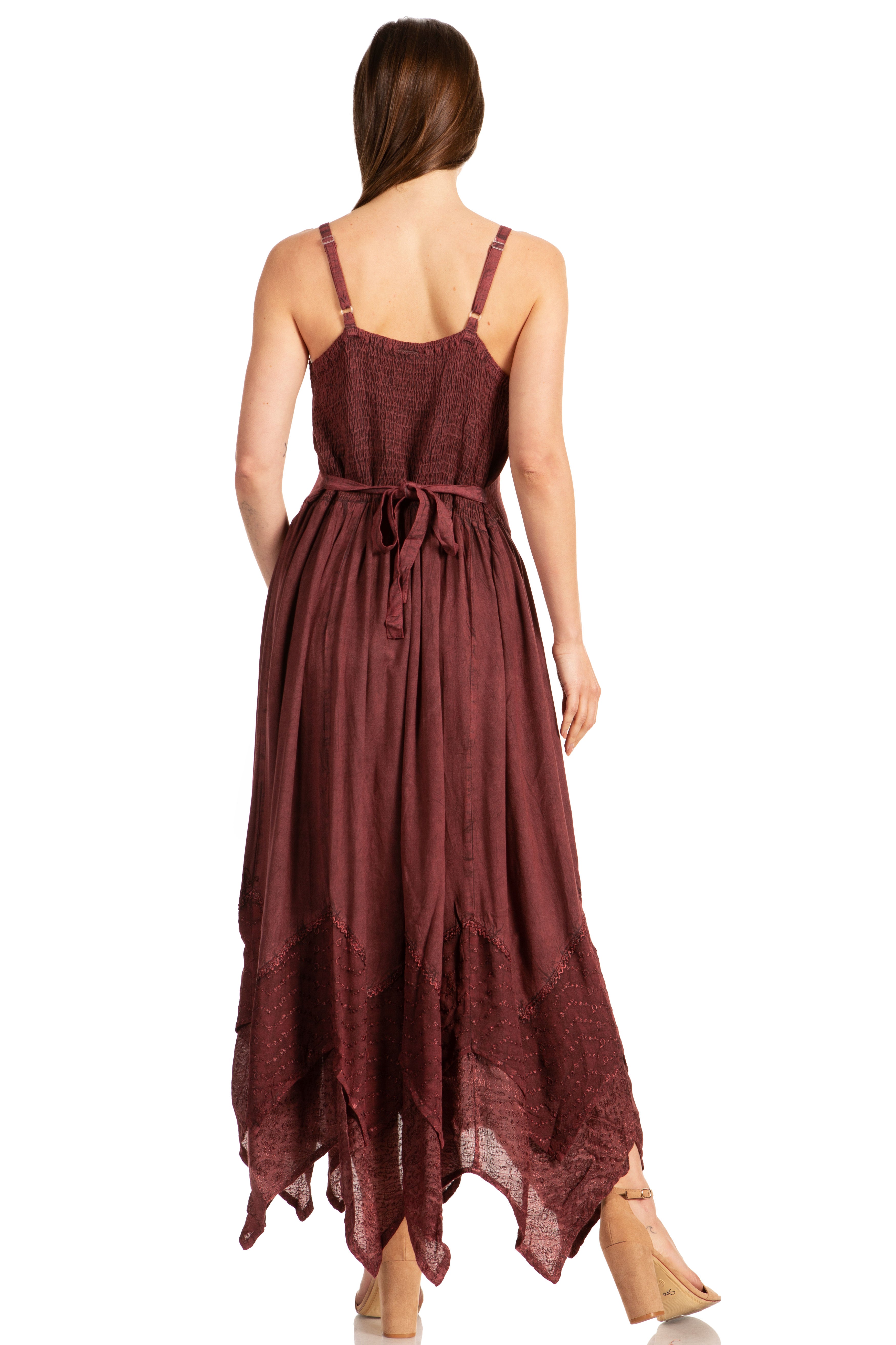 Woman wearing a burgundy dress with thin straps on a white background