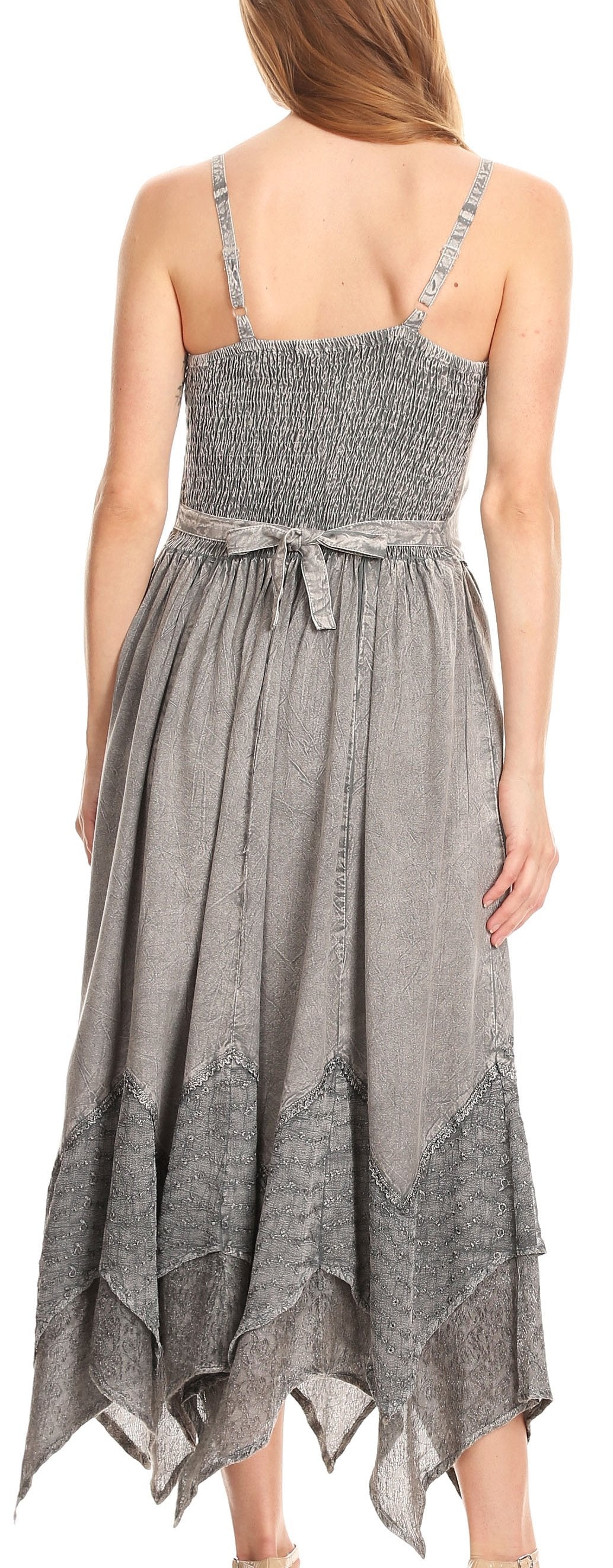 Woman wearing a gray patterned dress with a white background