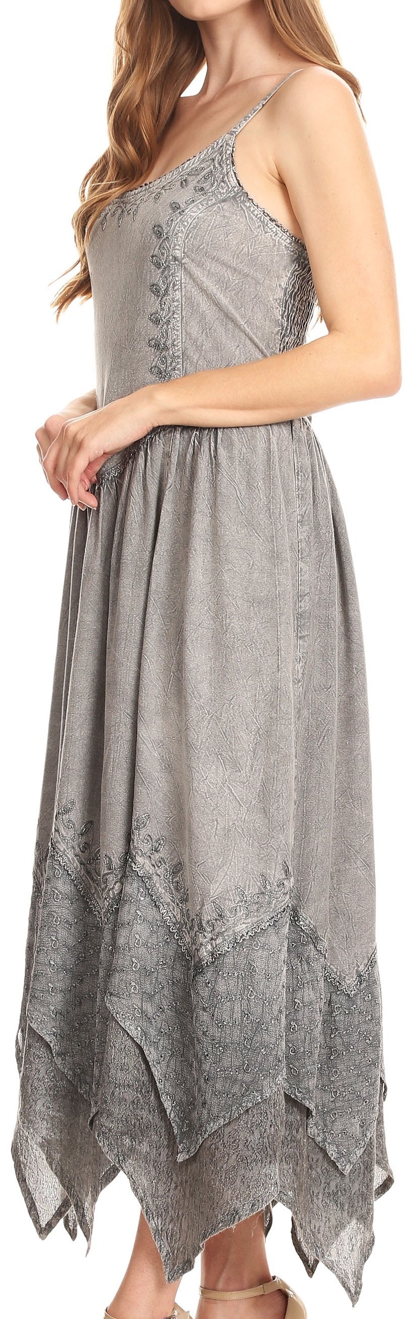 Woman wearing a gray dress with lace details on a white background