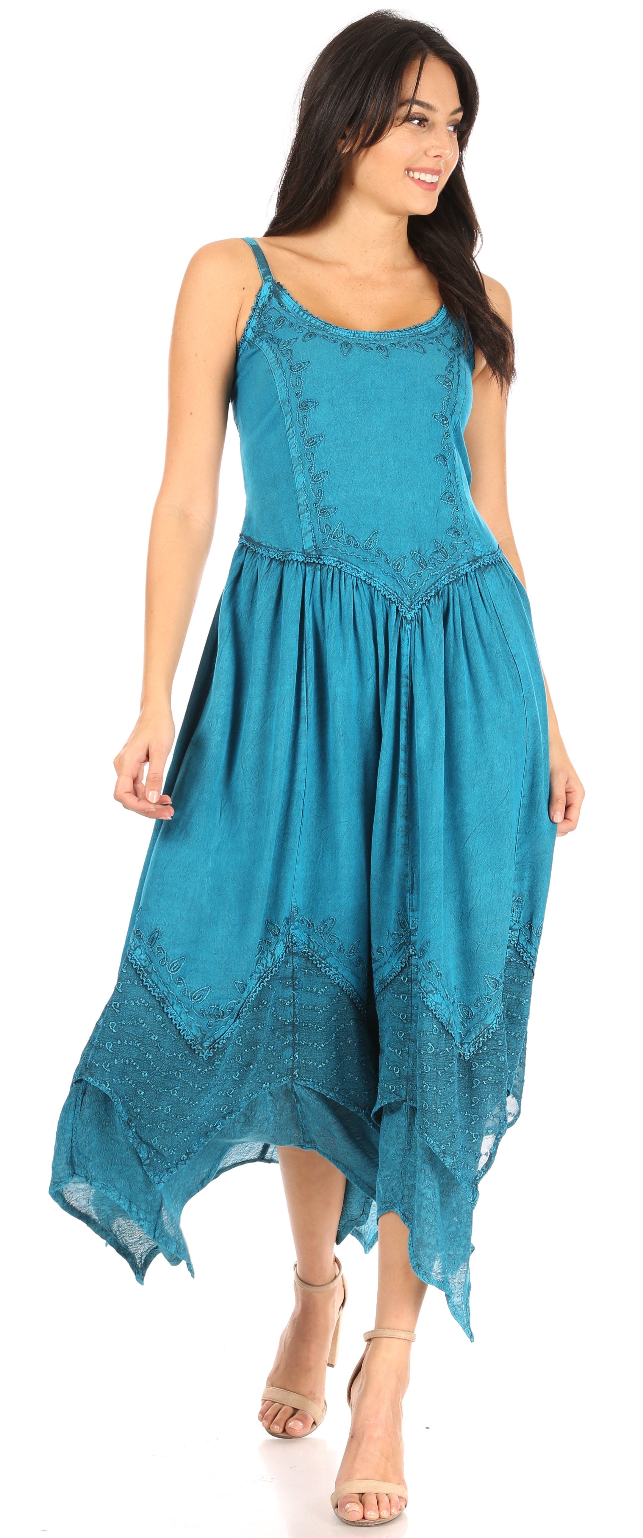 Woman wearing a teal dress with lace details on a white background