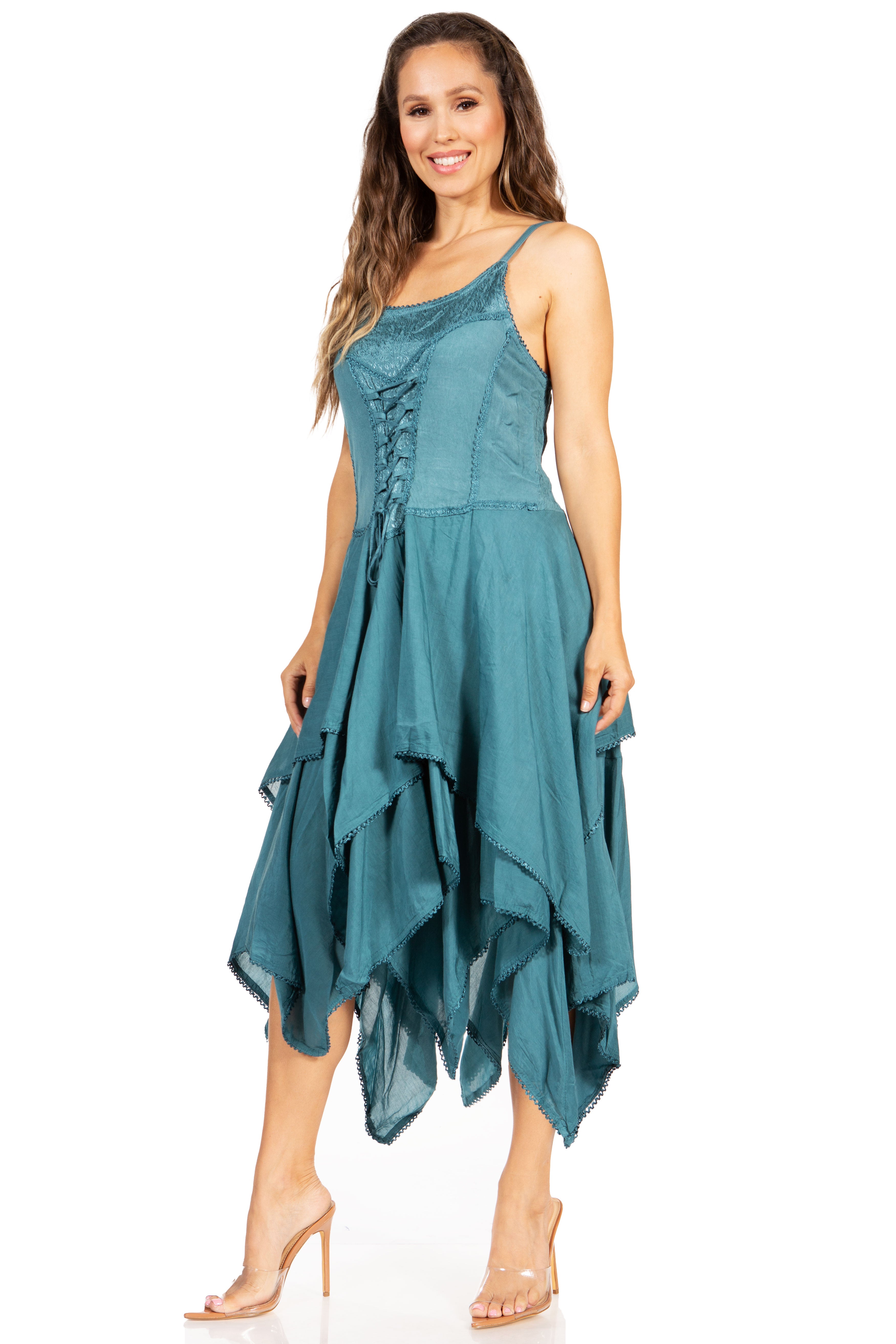 Woman wearing a teal dress with a white background