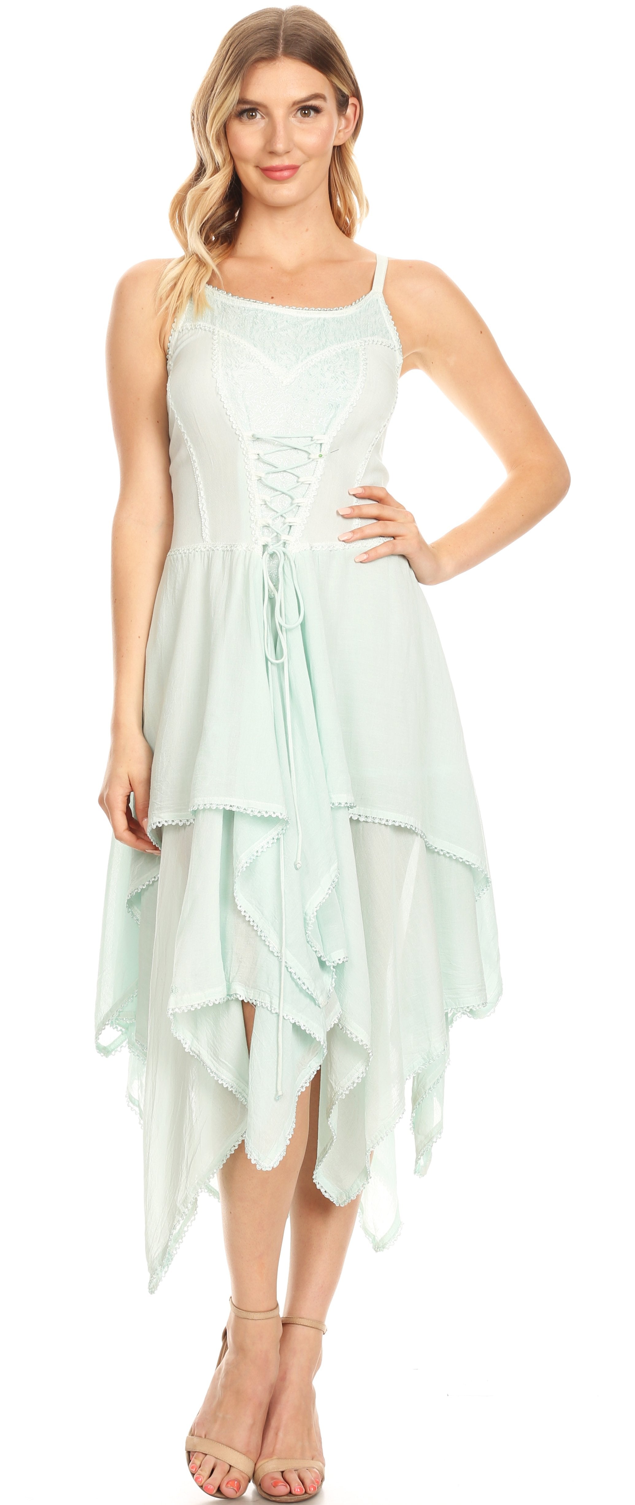 Woman wearing a light green dress with a flowing skirt on a white background