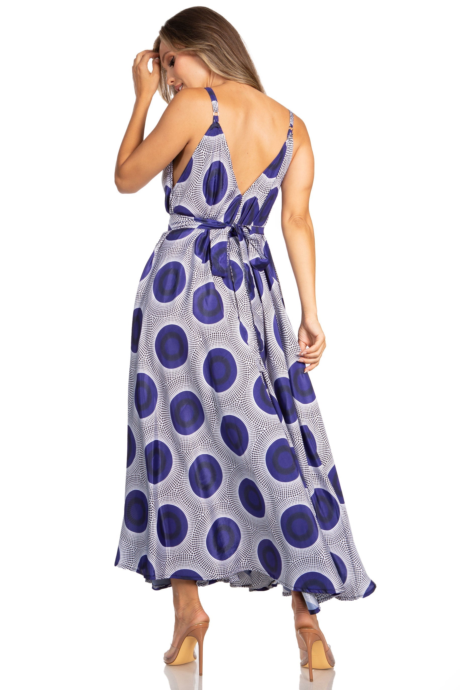 Woman wearing a blue and white polka dot dress on a white background