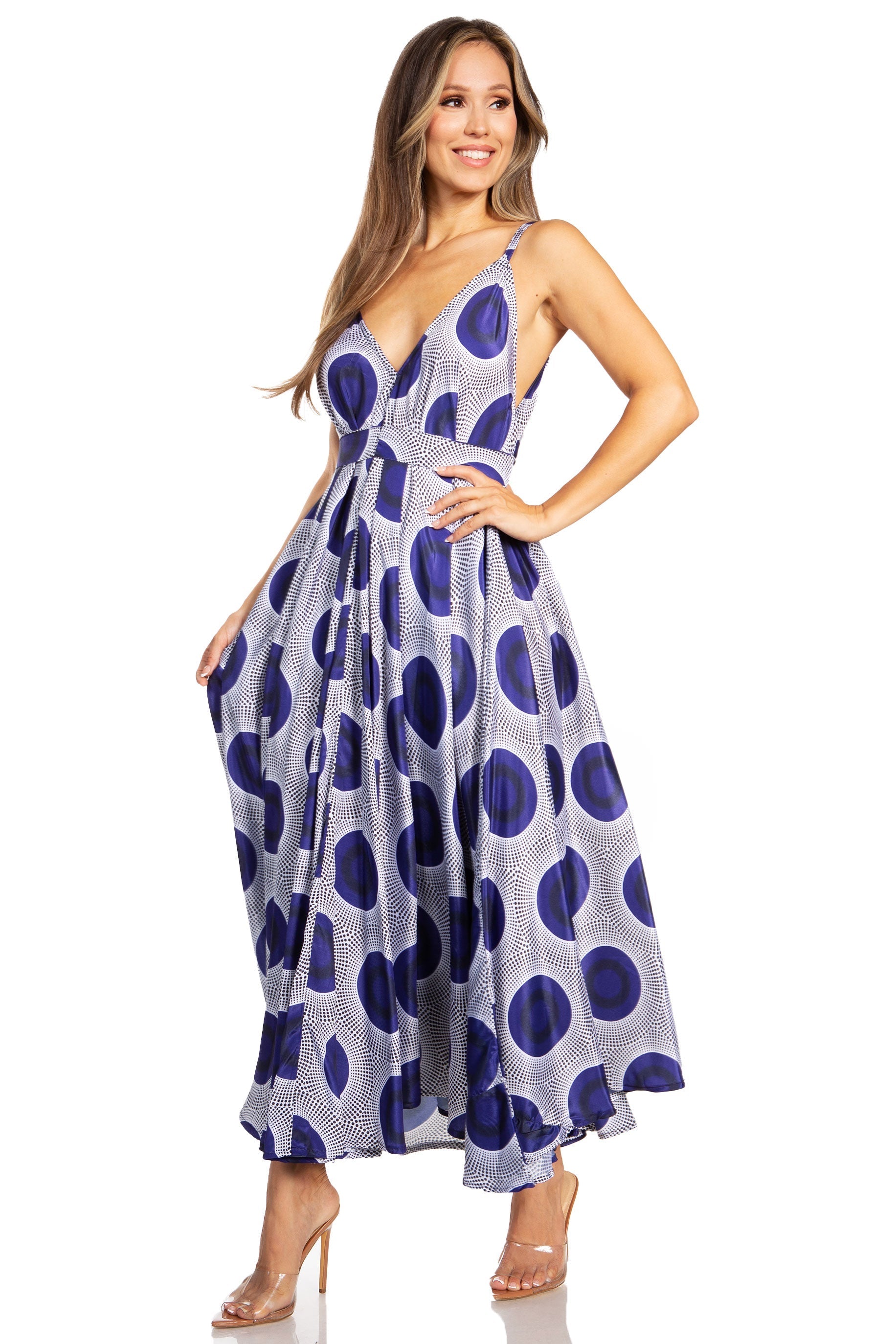 Woman wearing a blue and white polka dot dress on a white background