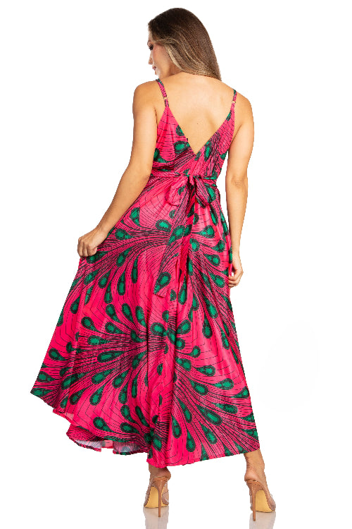 Woman wearing a pink dress with green peacock feather pattern on a white background