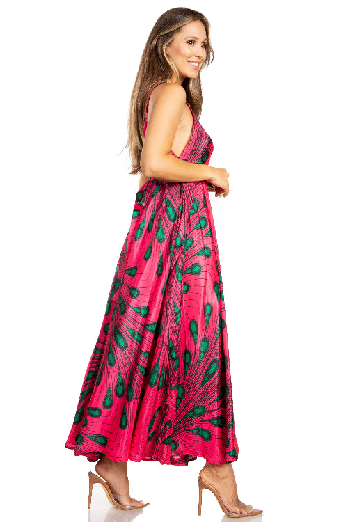 Woman wearing a pink dress with green leaf pattern on a white background