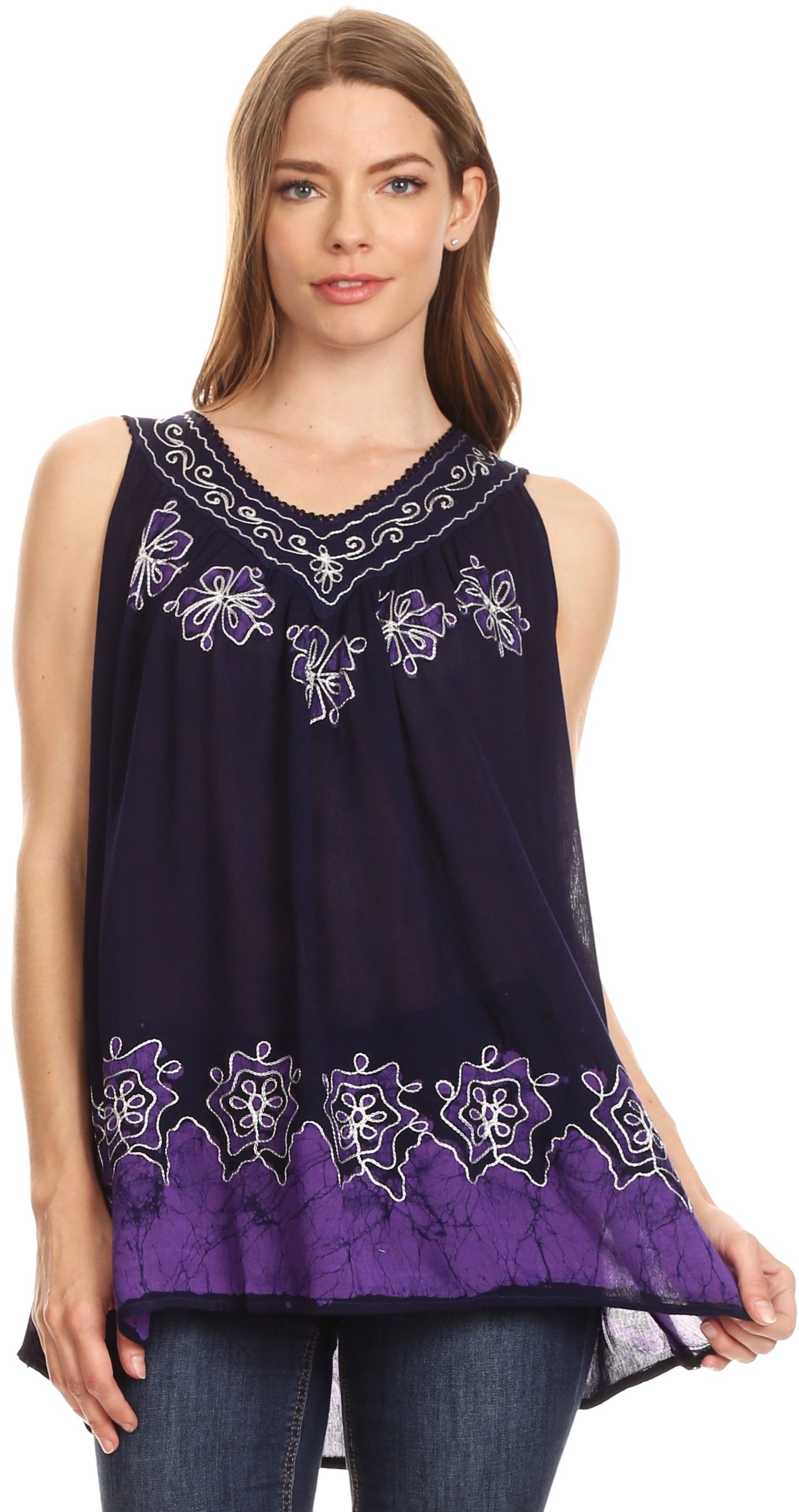 Woman wearing a sleeveless purple top with white embroidery on a white background
