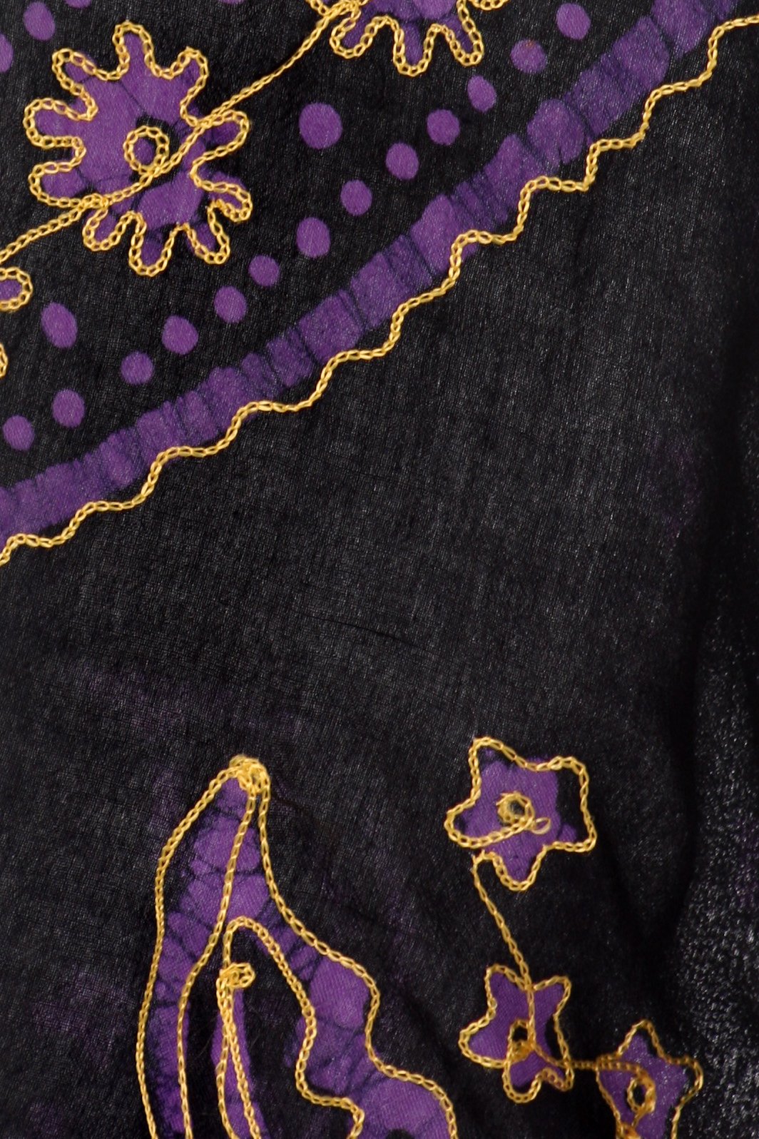 Black fabric with purple and gold embroidery